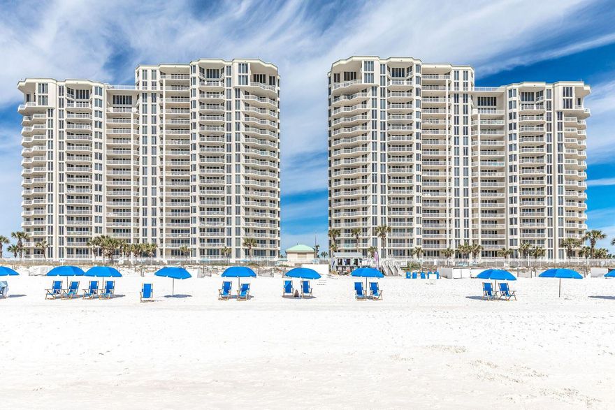 Seller offering to pay for two years of HOA dues to any buyer that closes before June 30th, 2025.  Beachside food and beverage service coming in 2025 to Silver Beach Towers! Who wouldn't want yummy food and tasty frozen drinks delivered right to their beach chair? Offering panoramic views, this completely remodeled gulf-front condo has a popular split floor plan. It is beautifully presented with all-new lighting, custom window treatments and graceful furniture included in the sale. New engineered wood flooring flows throughout the unit, giving way to new tile floors in all three bathrooms. The entrance hall welcomes with tasteful board and batten walls. It leads to two large guest bedrooms, both with generous private bathrooms and access to a private balcony. The hub of the home is the bright open living room, featuring plentiful windows and sliding doors onto the main balcony. Serve drinks from the beverage refrigerator at the custom bar before putting your feet up in this comfortable living space