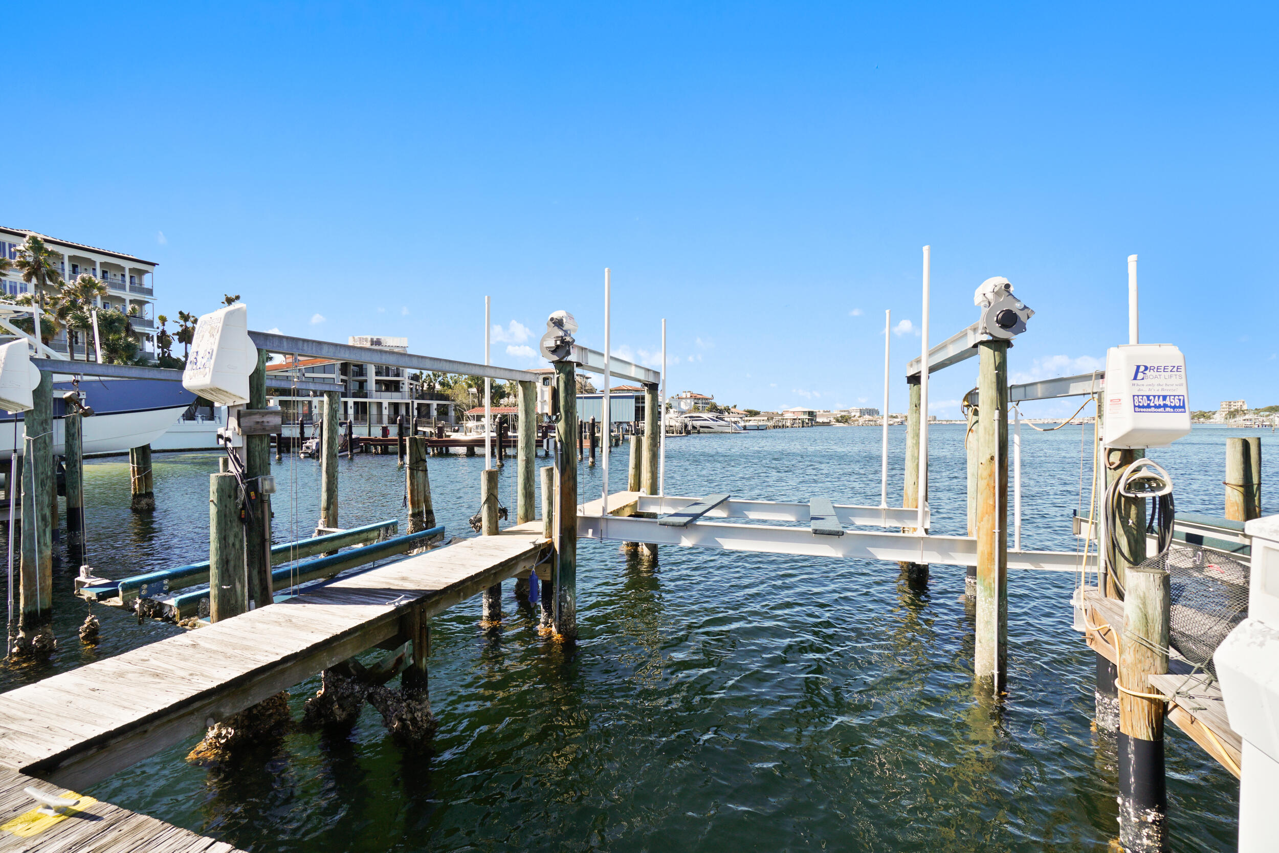 Rarely available Turnkey 2 bed/2bath Condo complete with Deeded Deep Water Boat Slip! 2A is a premium slip on A Dock on Holiday Isle & includes New 16k remote control Boat lift & upgraded power/water. Easy in & out boating access from your slip with no obstructions between you & the open harbor! Enjoy the convenience of this ground floor updated condo, only a short distance to the boat dock. Amenities include private gated beach access, large heated pool, pickle ball & tennis court, paddle board/kayak launch, grilling & beach area, golf cart parking & more. Fresh furnishings & decorations included (even Dart Board & Bumper Pool Table!), Washer/Dryer, & New Sofa/Love seat. Perfect for Full Time living, or AirBnb/VRBO. Solid Rental history & dozens of 5 Star reviews!