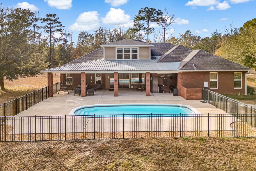 Simply no detail left undone! This custom built home offers exceptional craftsmanship and thoughtful design. Step inside to a grand entryway leading to a formal dining room and a dedicated office. The kitchen features custom maple cabinetry, granite countertops, a breakfast bar, and a walk-in pantry, overlooking the family room, Florida room, and sparkling saltwater pool. The split floor plan places three bedrooms on one side. With a MIL suite and a luxurious owner's suite on the other side of the home. Upstairs, a versatile fifth bedroom offers endless possibilities.  Enjoy the large driveway, 2 car attached garage and free standing 2 car garage with attached car port. Bring your horses or start your own mini farm, there is plenty of space for barns, riding trails and more. Enjoy the peace and privacy of no neighbors, nestled on 16+ private acres, this home provides the perfect blend of country living and convenience, just 5 minutes from DeFuniak Springs.  The best of both worlds. space, style, and serenity.  