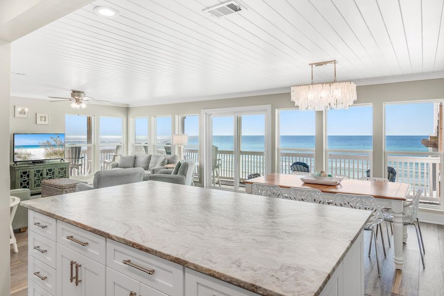 Remarkable gulf views abound from this third-floor beachfront condo at Sugar Dunes, which boasts private direct access from the balcony to the sugar-white sands below. Featuring three bedrooms and three full baths, this corner-unit condo has a wraparound balcony for taking in sunrises, sunsets and sea breezes. Completely renovated and professionally furnished and decorated so it is rental-ready, this unit is nestled in a quiet cove at the end of a dead-end street in a building with elevator that hosts only 24 units. Inside take in unobstructed views of the Gulf of Mexico from the wall-to-wall windows in the living room, which features a fireplace. A brand new kitchen with leathered granite countertops, new appliances and island seating were part of a complete remodel finished in early 2021