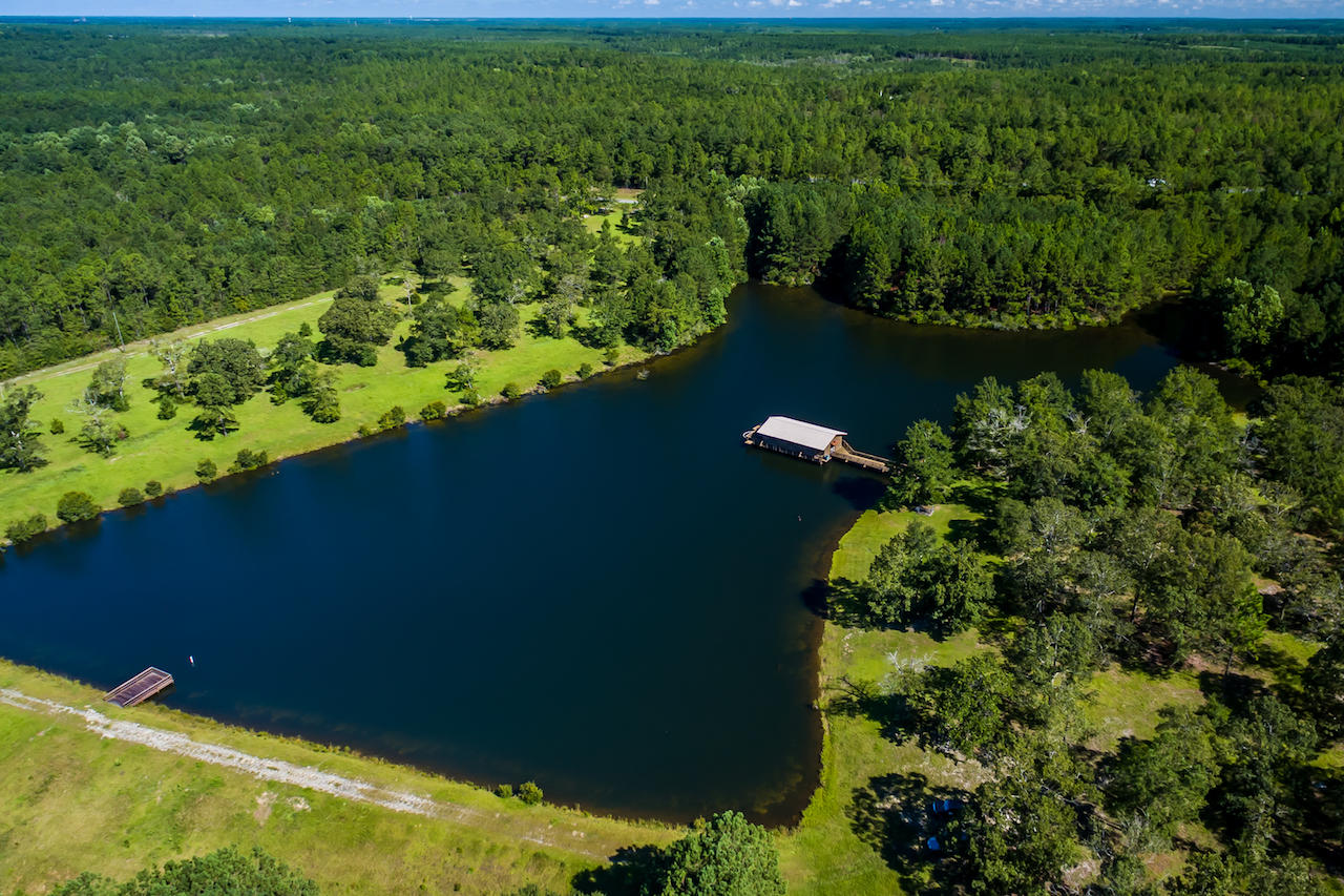 This 40 acre parcel is considered by many to be one of the finest freshwater fish camps in Northwest Florida. The custom built 8-9 acre freshwater lake is stocked with Trophy Florida Black Bass, Catfish & Georgia Copperhead Bream. The 1224 S.F. executive cabin is built over the lake giving you a panoramic view of this outdoor recreational paradise (see pics! awesome). The land is a mixture of pasture, woods and rolling hills. Perfect for horses, raising cattle and hunting. High deer and turkey populations. Shown by appointment. Listing agent must accompany. 24 hour notice please. Cash offers only.