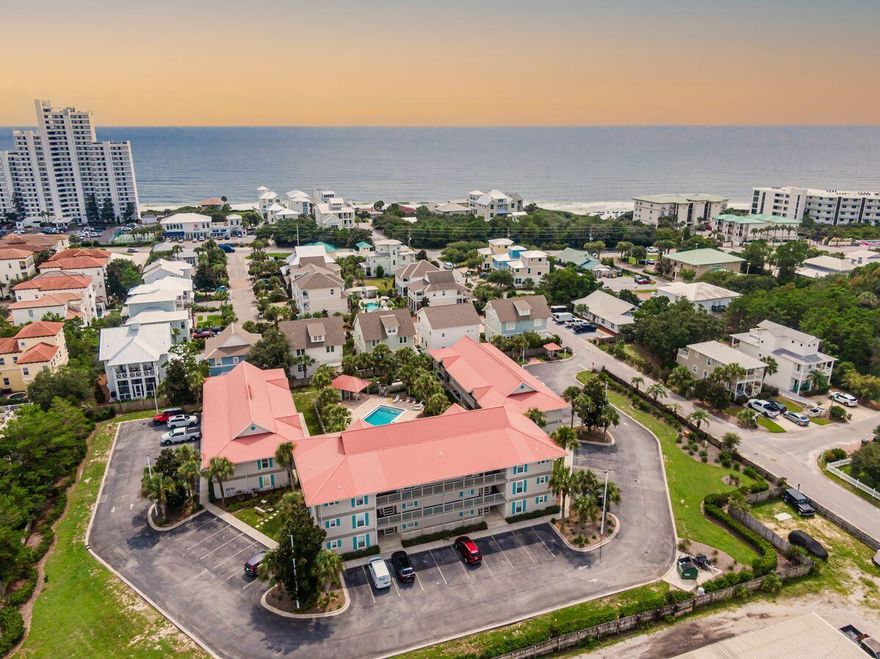 Immerse yourself in the beach lifestyle in this three-bed, two and a half bath condo in a quiet neighborhood two blocks from the beach. This Seagrove Beach unit features views of the community pool and the courtyard's well-tended landscaping from its ample balcony, while offering accommodations for up to 12 guests. A six-seat golf cart is included. The condo's main living area features an open-concept design that flows into a dining space for four and a kitchen with neutral cabinetry, breakfast bar seating for four and stainless appliances. The unit's three bedrooms include a king suite with en suite bath and balcony access, a bedroom with one queen bed and one twin and a bedroom with a second queen bed and twin-over-twin bunks. The two additional baths share a Jack-and-Jill bath.