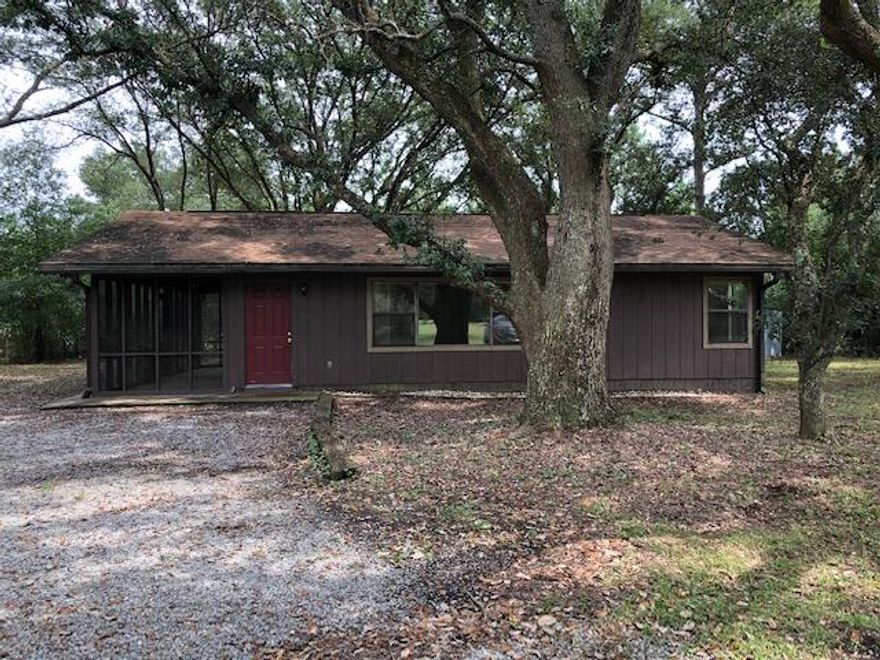 Enjoy the tranquility of country living on over an acre of land!  You'll have plenty of room to grow your own vegetables, let your pets roam in the yard or simply sit in the shade of one of the large trees surrounding the home. The interior of the home has been freshly repainted and all new windows were installed in September 2021. The large  screened porch is a great place to enjoy the country breezes or watch for deer and other wildlife.  There is also a shed and detached carport for your convenience. Call to schedule your showing today!