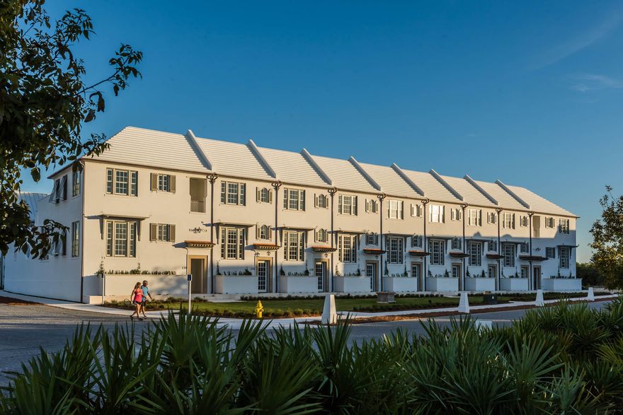 The newest completed homes in Alys Beach, Caliza Courts form a welcoming addition to the breathtaking Caliza Pool location. Designed by Khoury Vogt Architecture, the rowhomes are graced by an attached park along Somerset Street, with raised stoop entries bordered by landscaped planters. Brilliant details in design have been woven into these centrally located rowhomes.Finished in the artisan applied Venetian Plaster, the entry and stair hall ushers one in the main living area, elevated half a floor above grade. Spanning the width of the homesite, the light filled great room has a 16-foot ceiling and 12-foot tall French doors and windows that open to a private courtyard and guest suite beyond. The great room also features the reflective Venetian plaster finish on walls and ceiling.