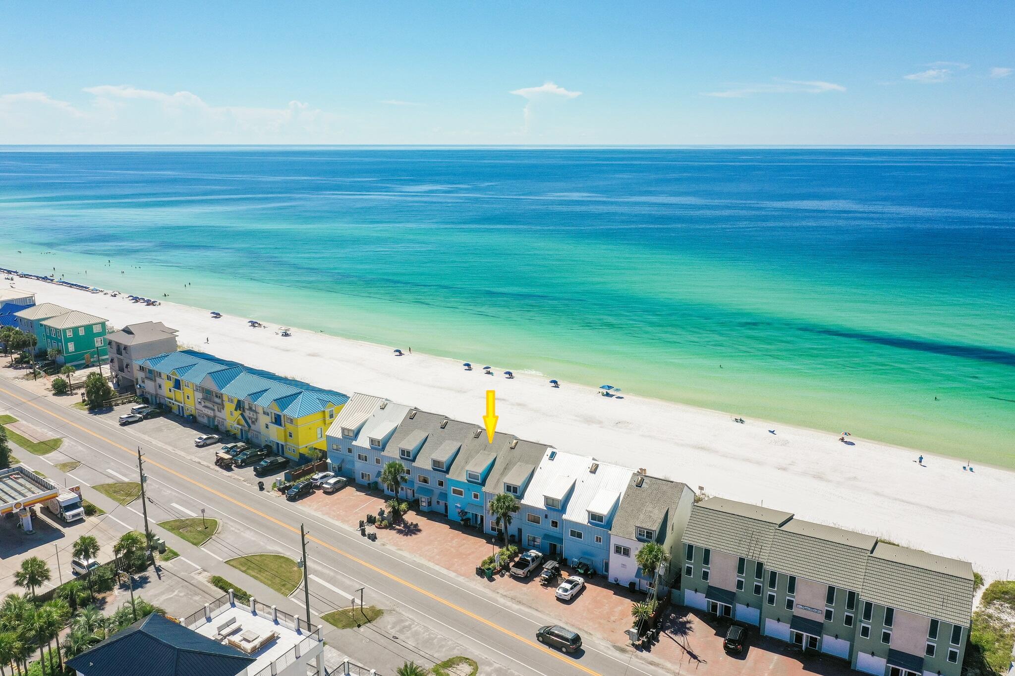 OWN YOUR PERSONAL PIECE OF PARADISE WITH NO HOA FEES DIRECTLY ON THE SAND. As opposed to private 'beach access', this large Gulf front townhome includes 22 ft of EXCLUSIVE, PRIVATE BEACH for ONLY owners & their guests. Offering stunning Gulf views from almost every room, live the Gulf front lifestyle you've always dreamed of while generating income when you're not there. Wake up to crashing waves & after a morning walk on the beach, enjoy your morning coffee on your large deck directly on the sand. This property is like having two homes in one. On the 2nd level, you'll find a spacious living & dining area, kitchen, BR & Bathroom. The large windows & 18-ft ceiling allow natural light to flood the space, showcasing stunning Gulf views. The white & blue interior creates a modern, beachy feel that perfectly complements the surroundings. As you ascend to the private, 3rd level master suite, enjoy amazing Gulf views. An additional bunk area adds versatility to the space.
The 1st level w/ a 2nd living area, kitchenette, BR, BA & another bunk room has newer LVP flooring and offers privacy for guests or extended family members & could be used as a lock out. Enjoy lazy days on the beach, and stunning panoramic Gulf views from the large Gulf front deck just steps to the sand! A large storage room is conveniently located at the back of the deck for hard-to-store items, like bicycles, floats, etc... The 2023 HVAC & NEW ROOF to be installed prior to closing provide affordable insurance & peace of mind. Whether you're looking for a primary residence, vacation home, or investment property, this Gulf front home comes fully furnished & is turn-key. Seawinds Townhomes is a community of 9 townhomes directly on the beach and unique in that ownership of these properties extends to the water and each owner has a private beach. There is parking for 4 vehicles and NO HOA. The owners do share in the cost, however, of lighting and landscaping and that volunteer cost is presently $1000 annually. Perfectly located in the heart of Miramar Beach, you'll have easy access to great restaurants, shopping, golf courses, and tennis facilities. Don't miss out on the opportunity to experience the ultimate beachfront lifestyle.