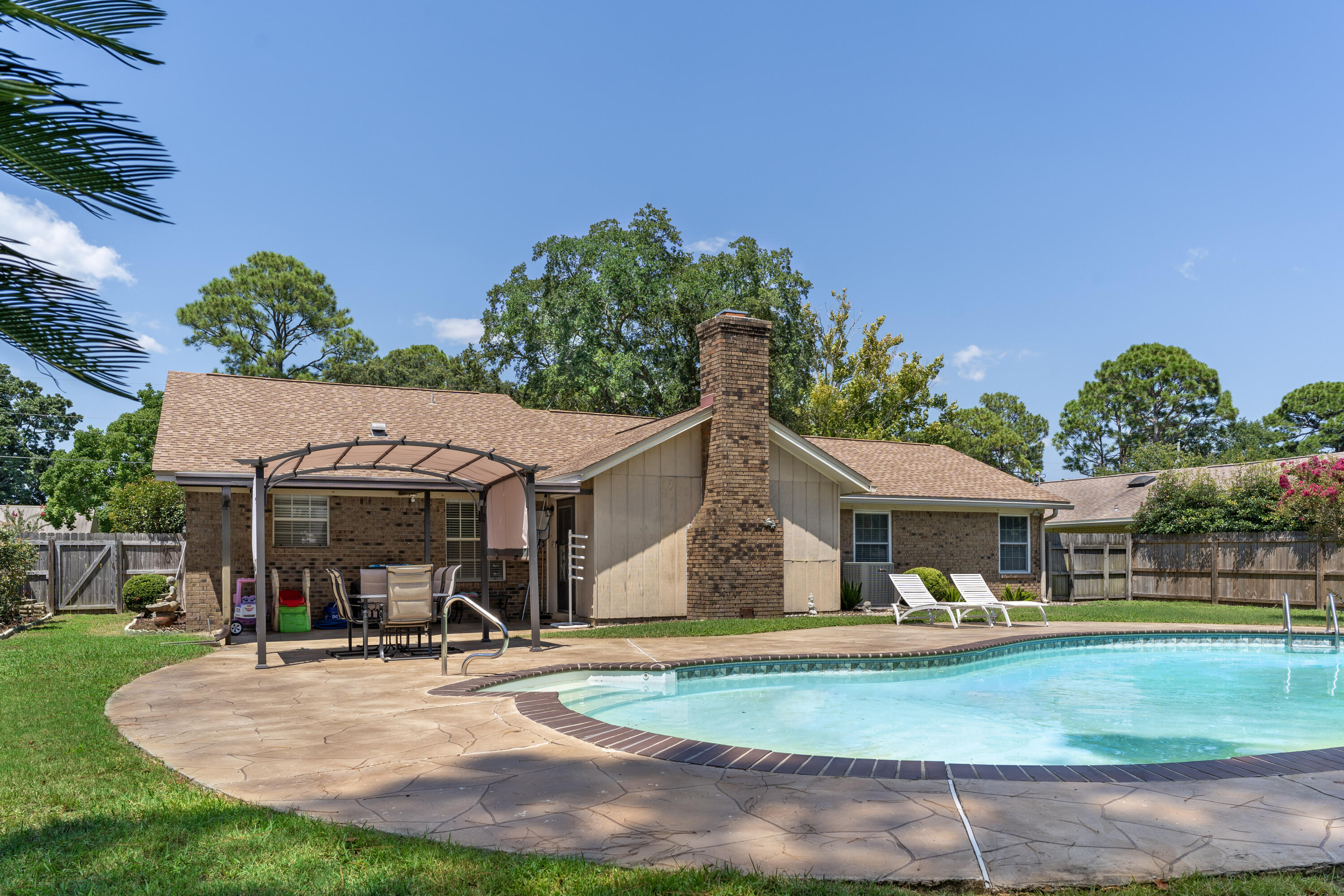 Pool Home with a fantastic yard! 3 bedrooms 2 full baths, 2 eating areas, Master has great nook area for desk or sitting area. Open layout with vaulted ceiling in living room and fireplace. Custom trim details. Good size secondary bedrooms. Roof 2016, HVAC 2018, termite bond, lawn pump for irrigation, 2 car garage, playground/park at end of street, great location to Hurlburt, shopping, restaurants, and beaches/bay. No HOA! Check out the virtual tour and pictures. Buyer to verify all deemed important information.