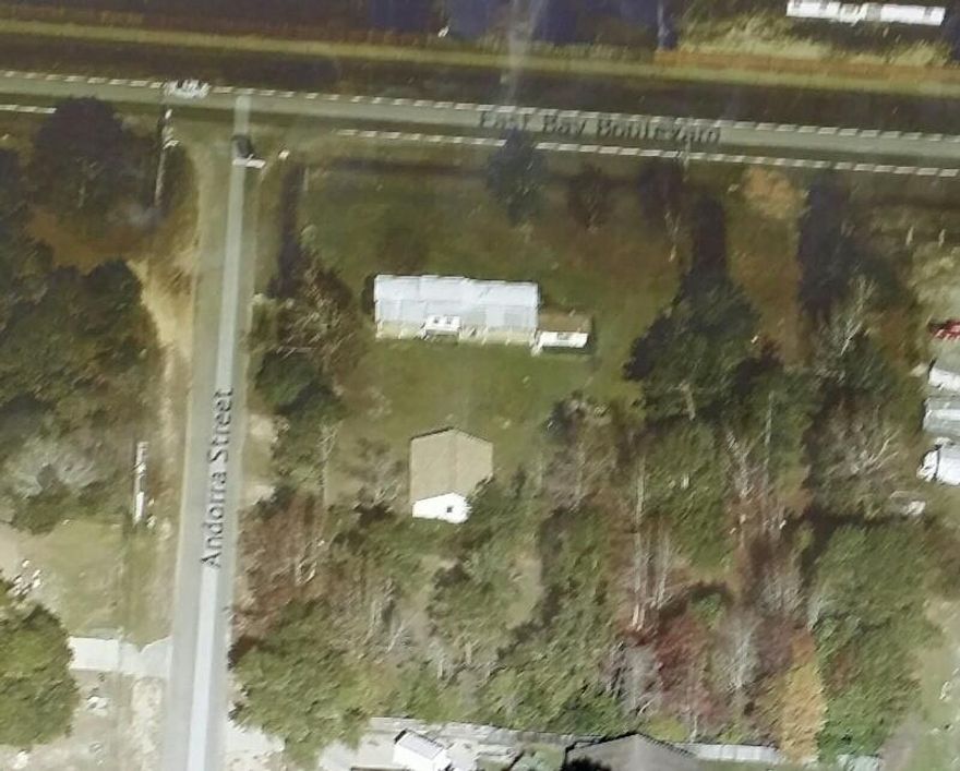 The rear 100 feet of the lot has just been re-zoned to HCD (Highway Commercial Development). All of the property is HCD. The property has a 24 x 36 Storage/garage building plus a 12 x 16 shop that will remain. Existing trailer is to be removed; however if it has not been removed by contract it will remain as well.