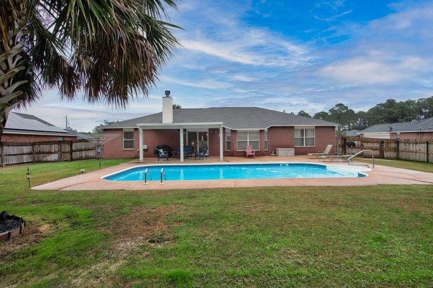 If you've been dreaming of space, sunshine, & a splash of fun, this one delivers it all! Welcome to this 4 BR, 2 BA beauty offering 2,129 square feet of comfortable living, perfectly situated on a generous .46-acre lot. The star of the show? Your very own salt-water pool, ready for cannonballs, quiet floats, & everything in between. Inside, the updated kitchen shines with granite countertops, wood laminate flooring, & sleek stainless steel Frigidaire Gallery Series appliances, perfect for everything from weeknight dinners to holiday spreads. The living room invites you to cozy up by the wood-burning fireplace on cooler evenings, creating the perfect balance of warm & welcoming. And let's talk peace of mind: all the major components have already been replaced! Water Heater (2026), Roof, HVAC, & Grinder System (2024), Privacy Fence (2023), & Pool Pump (~2022/2023). The big-ticket items? Handled.  Need extra storage or hobby space? The 10x14 yard building has you covered. The spacious backyard offers plenty of room to spread out, garden, play, or simply enjoy your private outdoor retreat. As if that weren't enough, the HOA amenities take things to the next level: featuring an indoor pool, waterfront clubhouse, basketball and tennis courts, exercise room, boat ramp, fishing, golf, & so much more. It's like having a resort right in your neighborhood! This home offers the perfect mix of updates, space, & lifestyle perks, all wrapped up in one inviting package. Come see why life is better with a pool in the backyard & amenities at your fingertips!