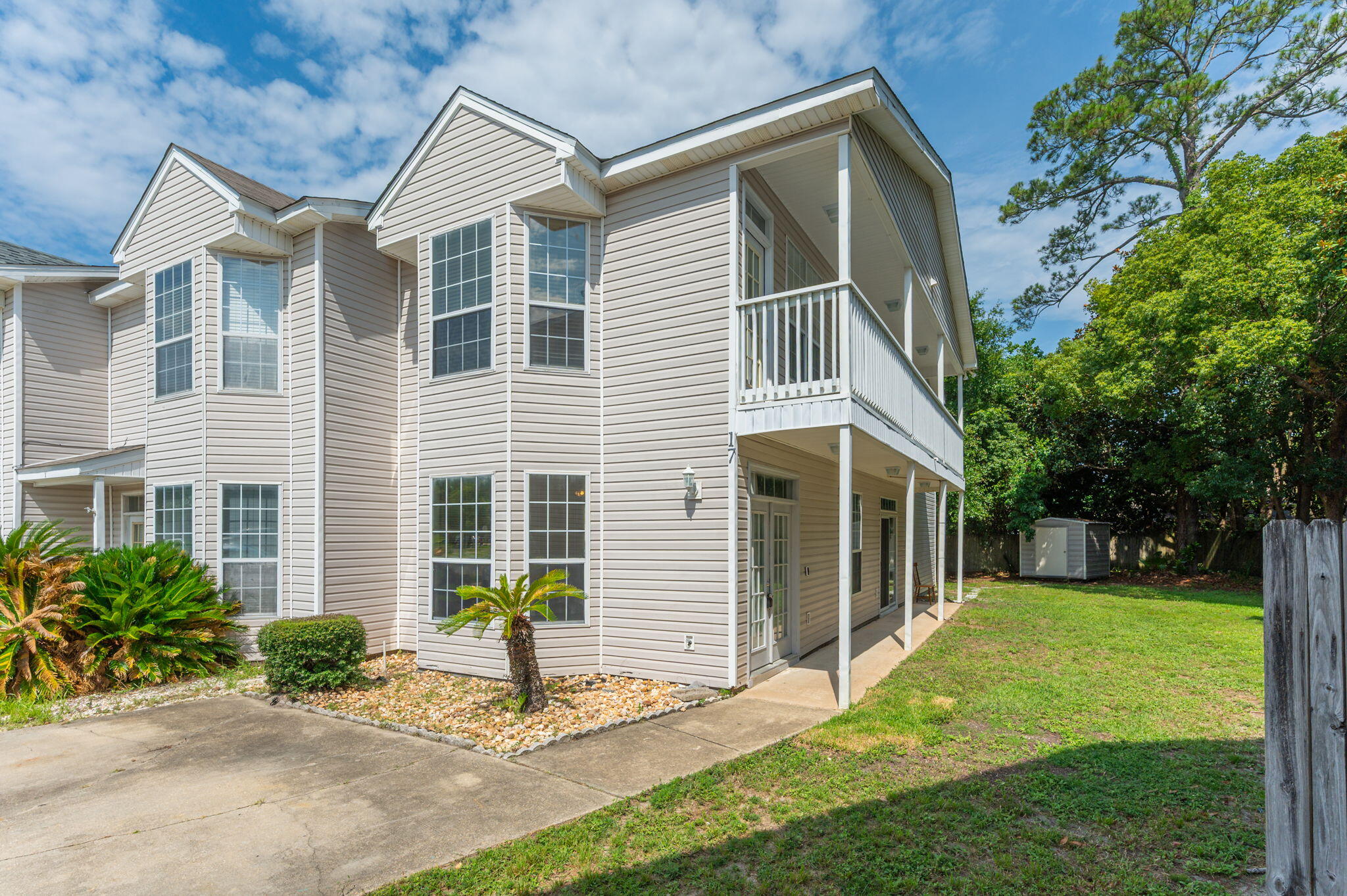 Welcome to this beautifully designed three-bedroom, three-bath townhome located in the heart of Fort Walton Beach. Step inside to find luxury vinyl plank flooring throughout the main living area, complemented by a bright bay window that fills the living room with natural light. The kitchen features a convenient center island, sleek black appliances, a pantry, and a peek-through cutout connecting to the dedicated dining space--perfect for entertaining. Downstairs, you'll find a full guest suite with a painted accent wall, along with a generously sized bathroom vanity and ceiling fan. Upstairs is fully carpeted and includes a second guest room, full bath, and the spacious primary suite. The primary suite boasts a bay window with access to a private balcony, a double vanity, and custom shelving in the walk-in closet. With thoughtful design elements and plenty of natural light, this townhome blends comfort and function in a highly desirable location. Contact us today for your showing!!