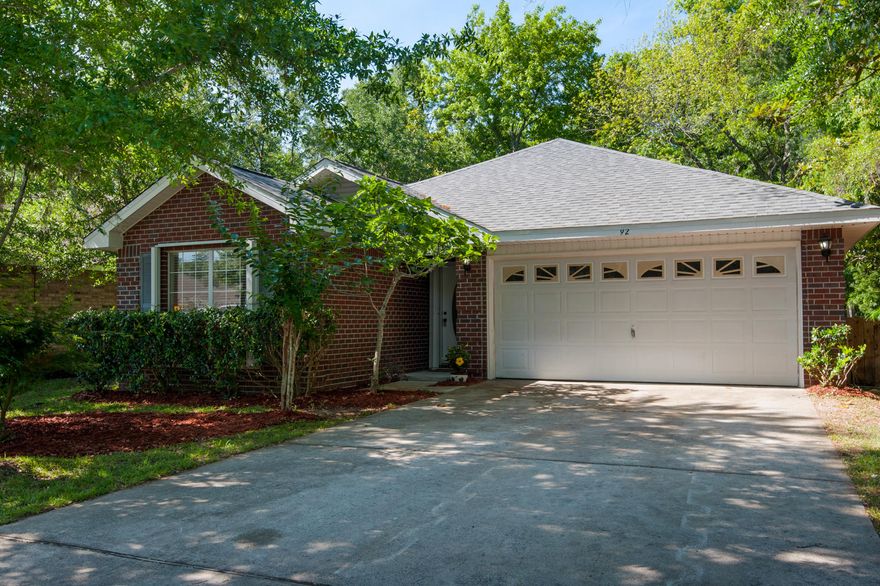 Excellent location. New Roof. New AC. All Brick. This 3 bedroom, 2 bath recently refreshed beauty has an open floor plan with new paint, new carpet, new tile and that's just the beginning. The Foyer greets with 20x20 designer tile that flows into the living space with vaulted ceilings and a cozy fireplace for those cool FL nights. The kitchen features BRAND new Frigidaire stainless steel appliances (Fridge included) with island and plenty of cabinets, plus pantry. Spacious dining space for casual eating or formal dinners and just steps out the French door is an open patio for Al-Fresco meals. Split floor plan with generously sized bedrooms and large closets. Enormous master suite with walk-in closet, crown molding and located at back of house for extra privacy. Master bathroom features a