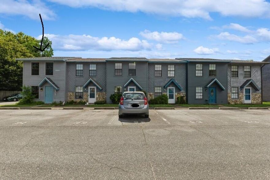 Move-in ready townhome, Upgrades include fresh paint and new carpet on stairs, tile floors throughout, chair rail in the dining area, granite countertops and stainless steel appliances in the kitchen, vanities in both bathrooms, new fixtures, and ceiling fans throughout. An ideal floorplan, the living area, kitchen, dining and half-bath are all located downstairs, with both bedrooms and a full bath upstairs. A spacious laundry room with shelving is also downstairs. Off of the dining room, step outside to a covered patio and you're a short walk to the community pool! The main bedroom features a spacious walk-in closet and an external door that walks out to a second-story deck.