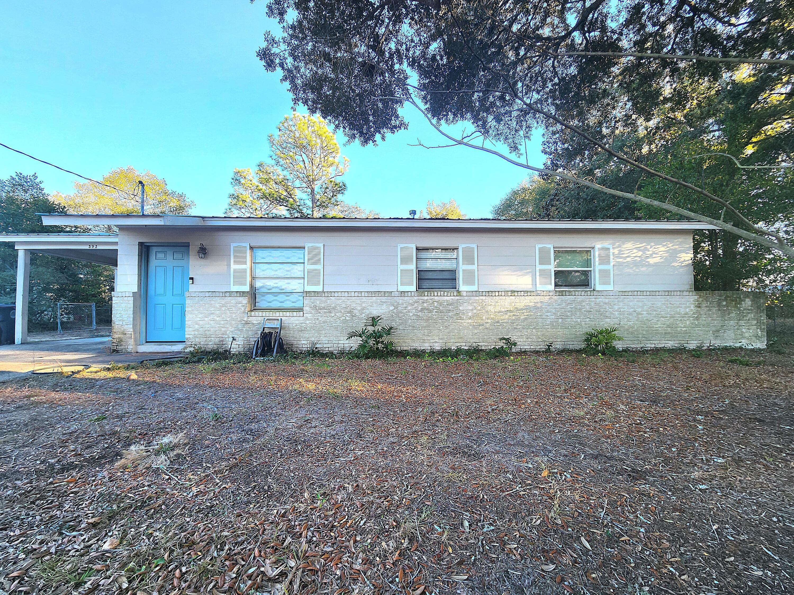 This adorable home is located on a quiet cul-de-sac near the East gate of Eglin AFB, just a short drive to beaches, shopping, and schools. It may need a fresh coat of paint and a little TLC, but it qualifies for financing and has so much potential. Many windows have been replaced with double-paned. The metal roof is in great condition, and extra insulation in the attic helps with energy efficiency. Inside, you'll find LVP flooring in the main living areas that 's like new, and carpet in the bedrooms. Bead-board accents add a quaint, cottagey touch. The water heater and sewer line from the house to the road were replaced 2019-2020. Shed in the *huge* backyard conveys. This is YOUR CHANCE for that real estate deal you've been looking for--don't miss out!