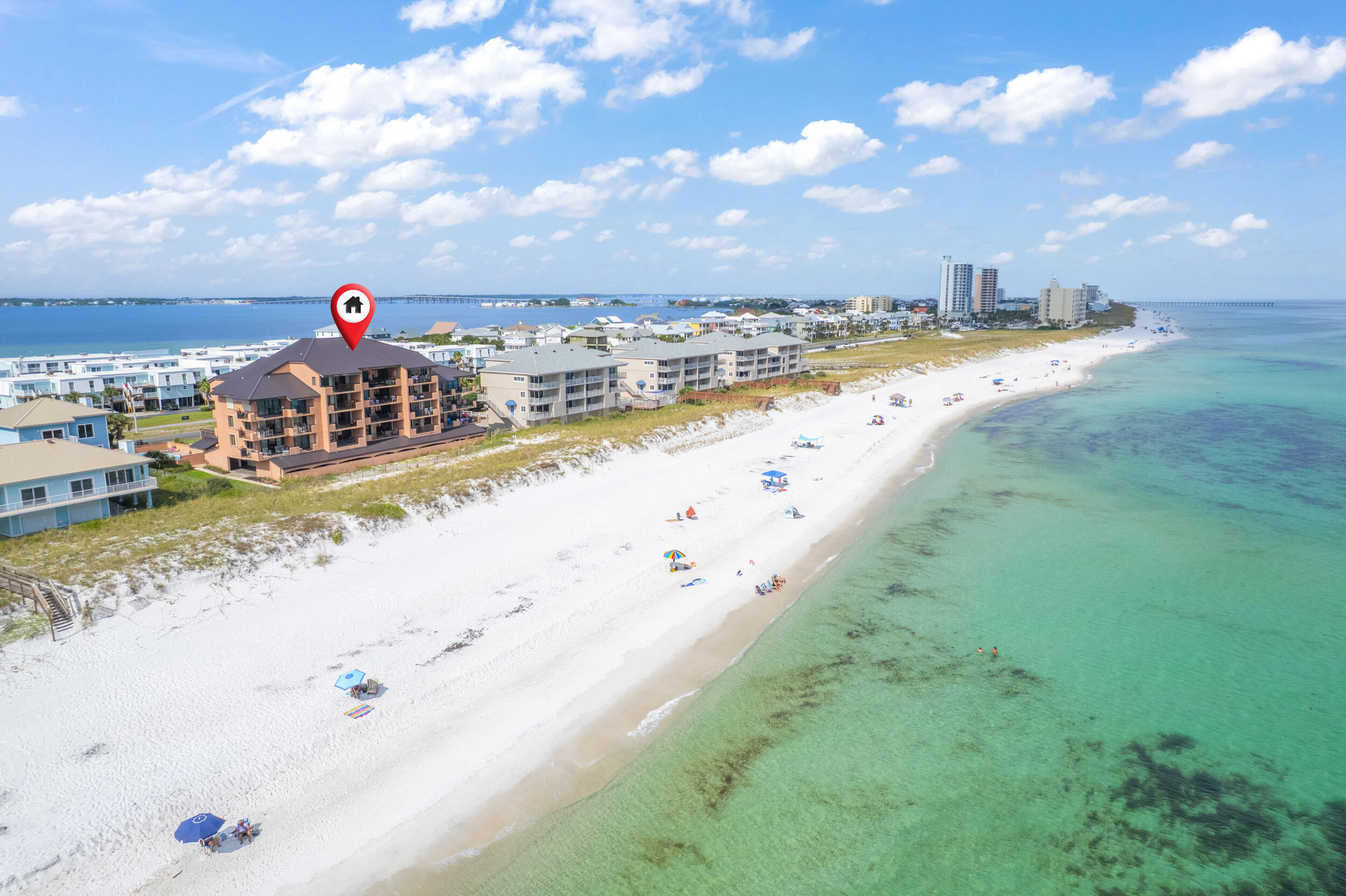 Just steps from the sugar-white sands and emerald waters of Pensacola Beach, this FULLY FURNISHED Gulf-view condo offers beachfront living and strong investment potential! This well-maintained 2-bedroom, 2-bathroom unit is a powerhouse on the rental market (Rental projections coming in at $63k!) yet also offers the flexibility to serve as a primary residence or a relaxing second home. Ideally located directly across from the elevator, you're just steps from your front door to the sand, pool, and everything the complex has to offer! Inside, the open floor plan highlights sweeping views of the Gulf, filling the space with natural light and coastal charm. The spacious kitchen features abundant cabinet storage and a convenient pass-through window to the breakfast bar, allowing for both water views and easy entertaining. A dining area with room for a full table sits adjacent to the breakfast bar, while the living room features retractable interior shutters and a generous 23' x 8' balcony, which also houses a closet for outdoor storage! The primary suite is a peaceful retreat with direct balcony access, two closets, and a private en suite bath. The second bedroom is tucked away in a separate hallway with a full bath nearby, offering privacy for guests or family members. Gulf Winds is a low-rise, smaller scale complex prized for its Gulf-front location and walkable access to Pensacola Beach's dining, shopping, and entertainment. With a swimming pool, private beach access, it offers the best of beach living without the overwhelming scale of larger resorts. With its open layout, private balcony, and fully furnished interiors, this condo is move-in ready and designed for effortless coastal living!