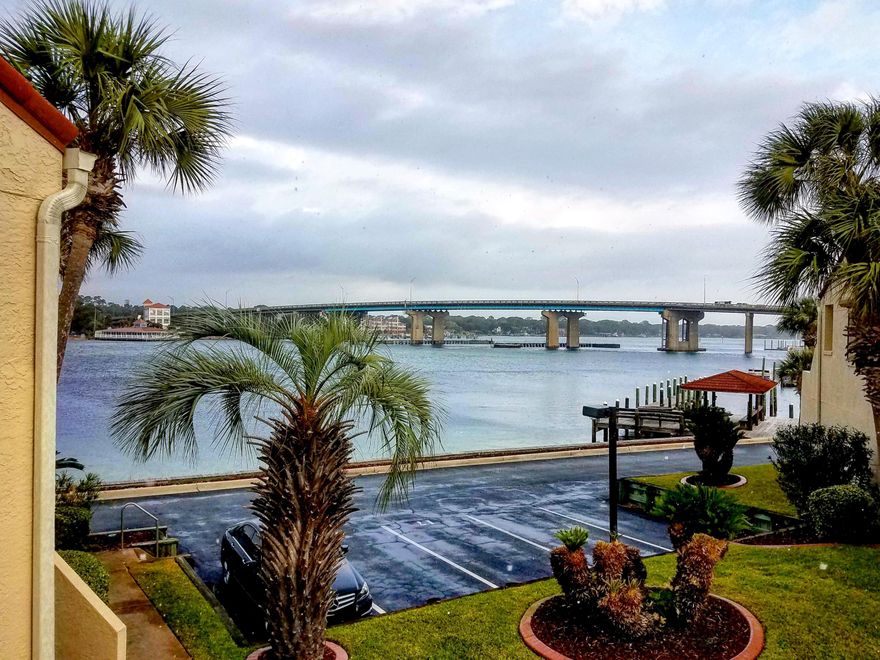 PRICE REDUCED! Only unit in the complex for sale! Amazing view of the sound from the living room. These units aren't for sale very often. A 50' deep water boat slip conveys with unit! The living room has luxurious pewter grey planks, tin ceiling, modern ceiling fan, nautical cedar encased beam, HVAC is one year old, water heater is less than a year old. A very short walk to the beach via the boardwalk behind the complex! The entrance is into the living room and kitchen, where there are vaulted ceilings, a half bathroom and laundry area (with washer and dryer). Wood stairs lead to the ground floor,2 bedrooms and each have their own bathroom.There is a downstairs patio.The unit has no carpet. Sailboat in slip is negotiable separately. If rented, has to be min 6mo lease