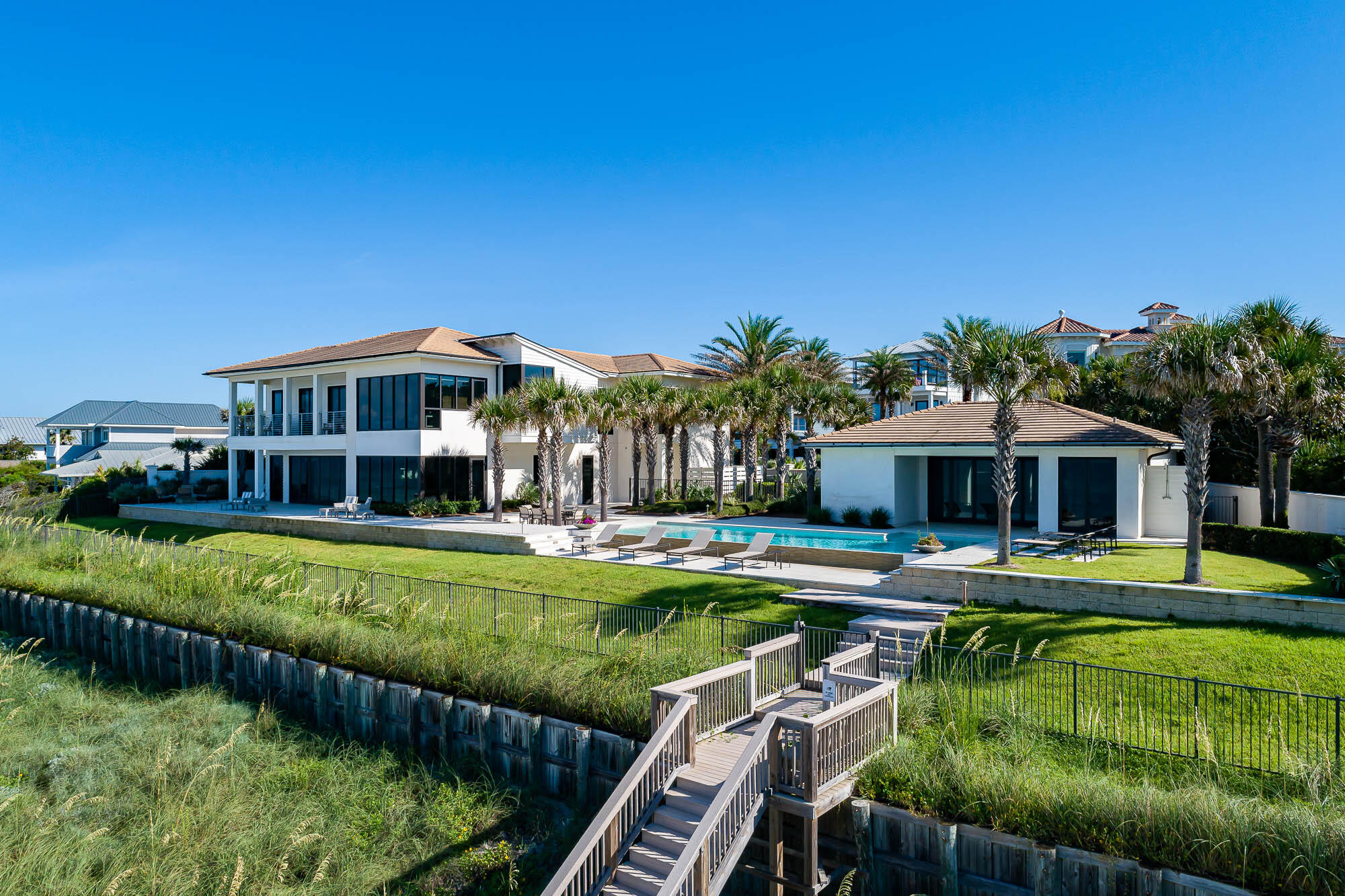 A notably rare opportunity to purchase a sprawling beach estate spanning 220 feet on the Gulf, on 30A's prime east end. This sale includes two Gulf-front lots. Exclusive and private, this waterfront estate is the largest gulf-front home site available along Scenic Highway 30A. Enjoy your home, guest home, and pool on 220 feet of pristine white beaches on the Emerald Coast. This beachside home is solidly built, and secure with gated entry, surrounded by a 6-foot privacy wall, and has an approved seawall that is deemed permanent by the Florida Department of Environmental Protection. Located in the gated community of Pelican Pointe, this prominent location is on 30A's east end, adjacent to the coastal dune lake of Camp Creek Lake, lending a quiet serenity, while also close to the lively