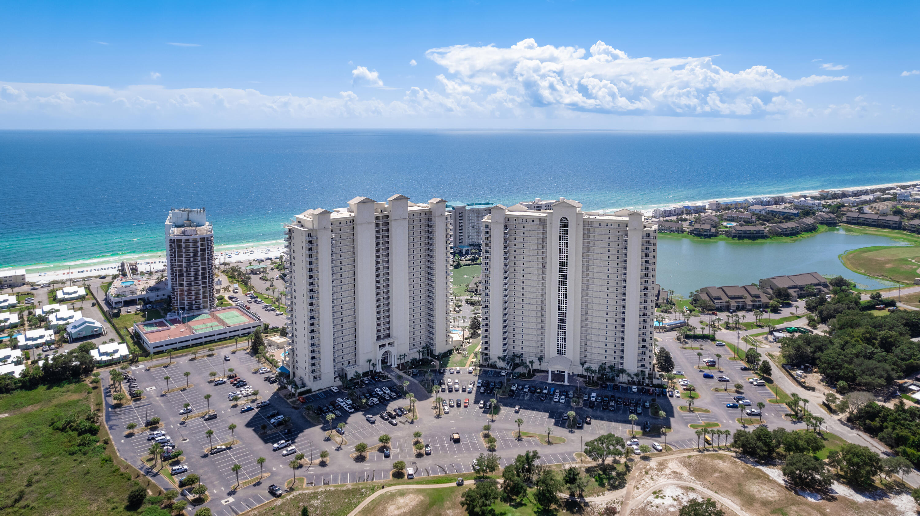 Enjoy breathtaking views from the 21st floor at Ariel Dunes! This two-bedroom two-bath unit with a bonus bunk room features a spacious private balcony accessible from both the living area and master suite, nine-foot ceilings, granite kitchen countertops, large glass sliders to enjoy the views, and much more! Wake up to stunning Gulf views from the master suite, or enjoy Bay views from the guest suite. With tile in the main living areas and bathrooms and plush carpet in the bedrooms, this unit is cozy and ready to be enjoyed. Enjoy the private gym and pools that are part of Ariel Dunes. As part of Seascape Resort, you also have access to an 18-hole golf course, tennis facilities, 2,000 feet of beach front, shopping, entertainment, and restaurants at the Towne Centre, and more. Paradise!