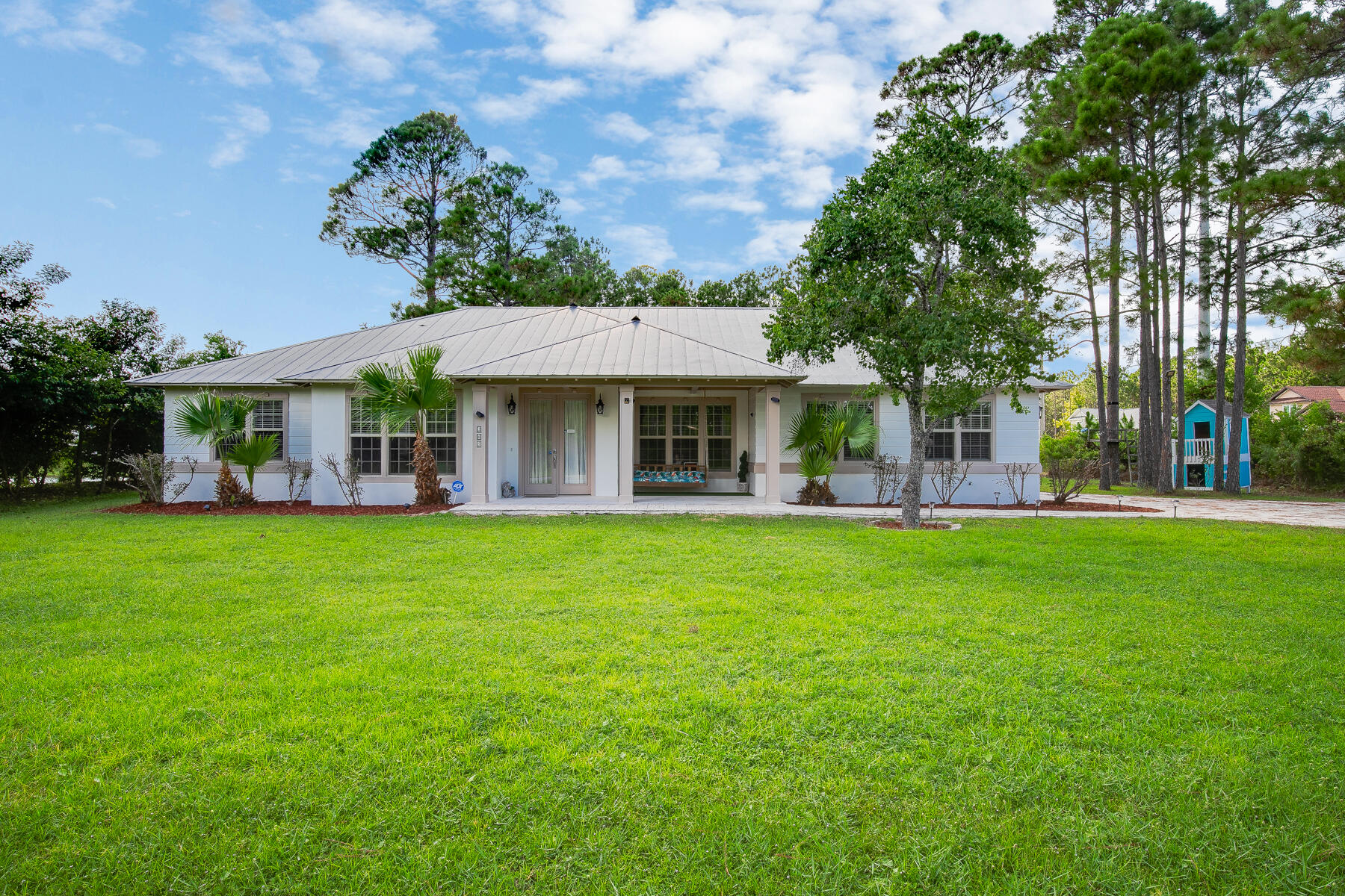Welcome to YOUR fully renovated home! Ideally located just minutes from top-rated shopping, dining, and the world's most beautiful beaches, this unique property stands out from the rest. Completely updated from top to bottom, it features brand-new tile flooring throughout and new stainless steel appliances that bring modern style and convenience to your kitchen. Built with care and character -- from the METAL ROOF to the custom finishes -- this home is truly move-in ready. Enjoy the flexibility of a bonus room perfect for guests, an office, or a creative studio. Relax in your master suite with a charming bay window bench and enjoy your favorite music through the built-in BLUETOOTH SPEAKERS in the shower.As a special bonus, the property also includes a beautifully maintained 24-foot tr