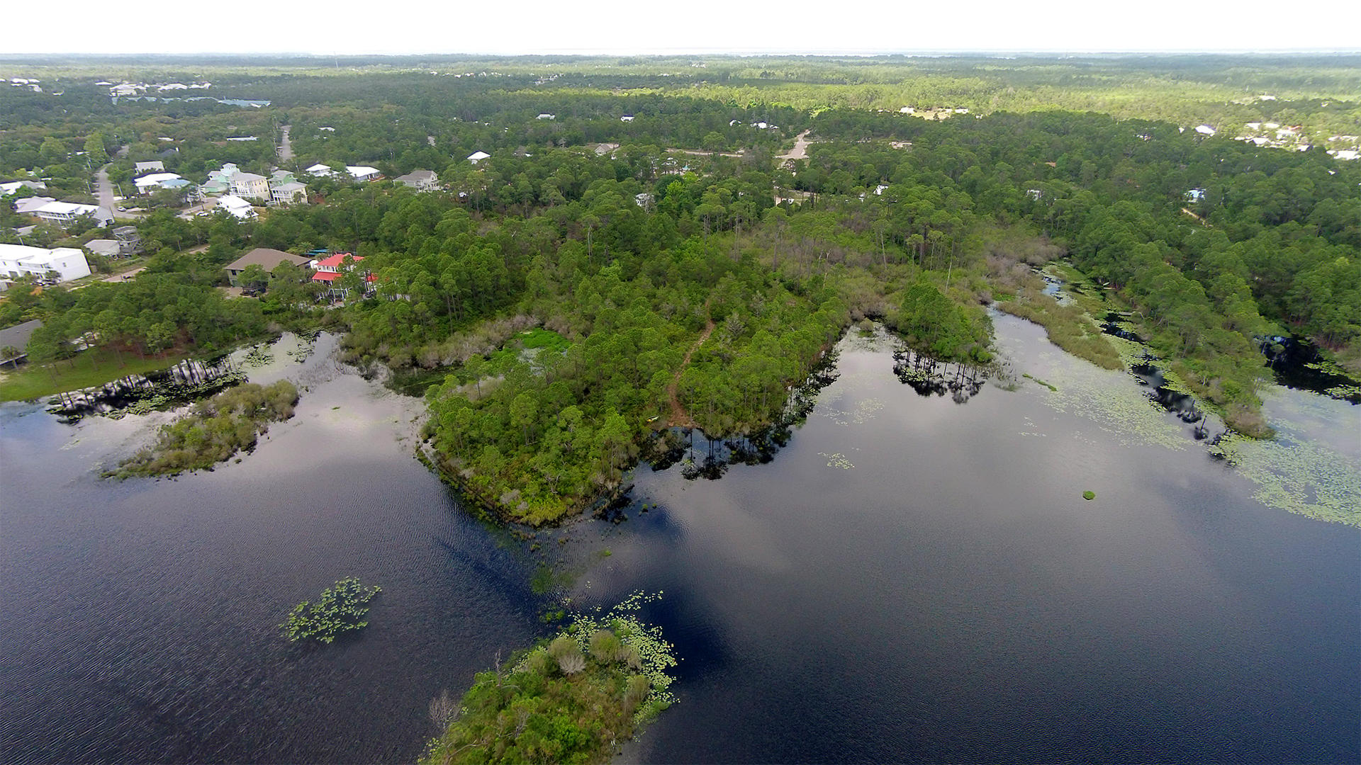 Amazing opportunity to own a large 1.14 Acre Lot on Dune Allen Lake. This lot has over 500 feet of lake front and potential Gulf Views. No association fees and just a short walk to the beach. See pictures & video for more detail. See you at the Beach!