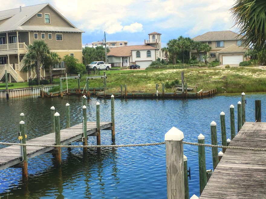 For all the Boat Lovers here is a special lot! With this Holiday Isle lot you can be on the canal, walk to the beach and be close to the harbor and restaurant. This lot is a large lot with 105 water frontage and an existing seawall and boat slip. This would make a beautiful homesite with gulf views from the second floor. The public beach access is located directly in front of norriego and gulf shore drive intersection.