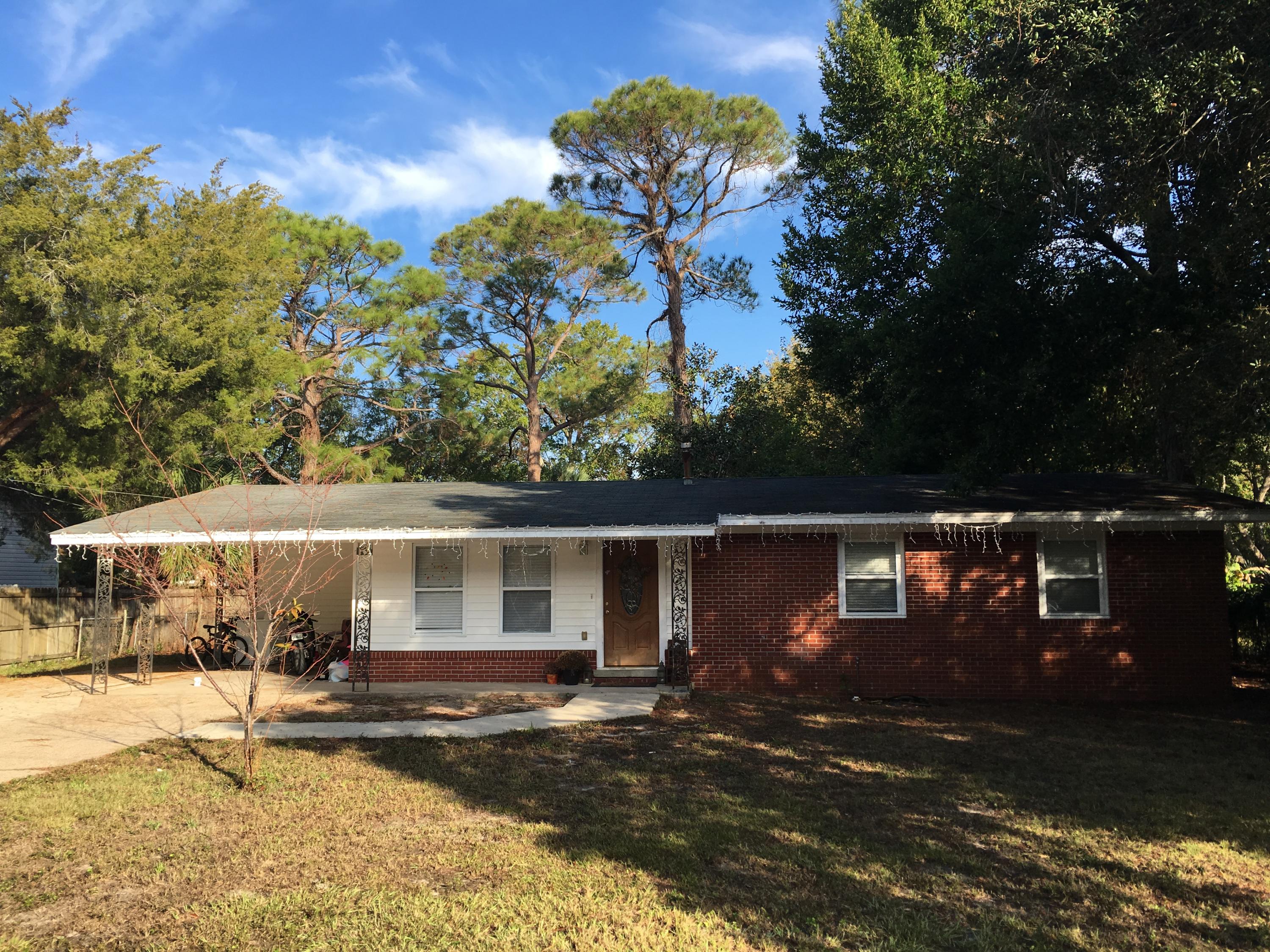 Beautiful home in the heart of Fort Walton Beach! New wood tile floors installed 2016. Wonderfully renovated kitchen with stainless steel appliances. Retro style bathrooms. The home sits on a .27 acre lot with a huge cleared backyard. Covered carport perfect for front porch sitting! Great location with many shops and restaurants near by.