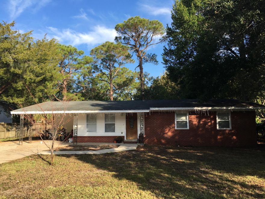 Beautiful home in the heart of Fort Walton Beach! New wood tile floors installed 2016. Wonderfully renovated kitchen with stainless steel appliances. Retro style bathrooms. The home sits on a .27 acre lot with a huge cleared backyard. Covered carport perfect for front porch sitting! Great location with many shops and restaurants near by.
