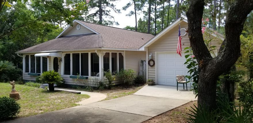 Adorable 2 bedroom , 2 bath cottage on a double lot and just a stones throw from the Boat Launch! Kitchen, dining and living room open with large screened porch on front of the house for those cool peaceful afternoons and a deck on the back ,under the shade trees for morning coffee! Seller built the home , says very sturdy and ''tight'' well built structure, both house and detached garage.No water in home with Ivan and not even a missed shingle! No Hoa and dead end street!All information deemed correct , buyer to verify.