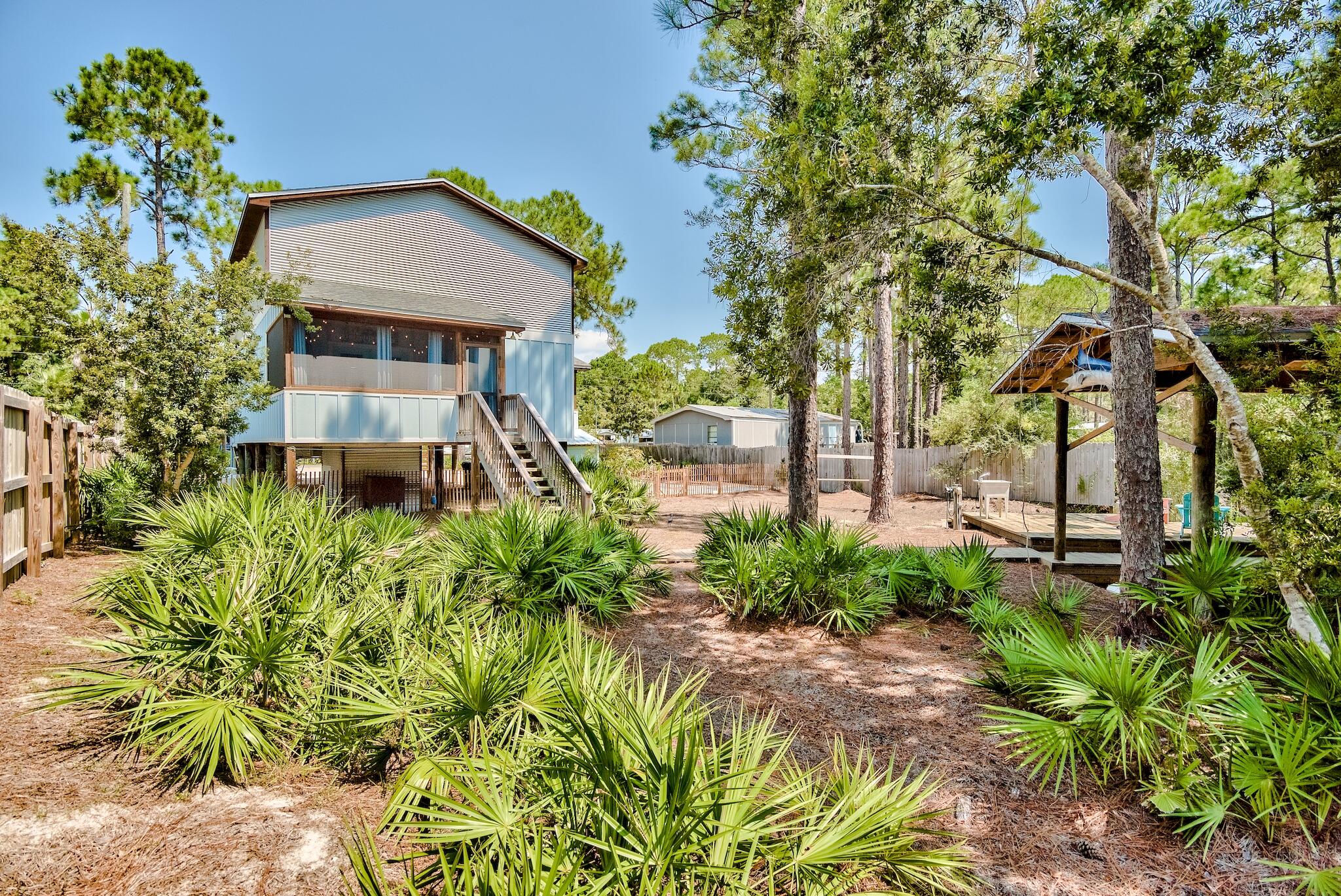 Blue Bayou is a beautiful, eclectic getaway with direct backyard shallow-water access to the Choctawatchee Bay off Hogtown Bayou. With reclaimed materials throughout, most sourced from a local farm house, yellow pine floors, 25 ft high soaring ceilings and private boathouse, this home is a true work-of-art. Amenities include, fenced yard, outdoor shower, kayak rack, screened porch, dock, outdoor sink/cleaning station, entrance gate and abundant parking. under-house storage area with mahogany detailing repurposed from a sunken boat. Indoor walls, floors and ceiling are thoughtfully filled with detail and texture. This is a rustic-modern gem grossing over $45K in short-term rentals in 2021. Remarkable revenue for Bayside; still just moments from the white sand beaches and Scenic 30A.