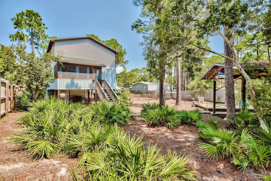 Blue Bayou is a beautiful, eclectic getaway with direct backyard shallow-water access to the Choctawatchee Bay off Hogtown Bayou. With reclaimed materials throughout, most sourced from a local farm house, yellow pine floors, 25 ft high soaring ceilings and private boathouse, this home is a true work-of-art. Amenities include, fenced yard, outdoor shower, kayak rack, screened porch, dock, outdoor sink/cleaning station, entrance gate and abundant parking. under-house storage area with mahogany detailing repurposed from a sunken boat.  Indoor walls, floors and ceiling are thoughtfully filled with detail and texture. This is a rustic-modern gem grossing over $45K in short-term rentals in 2021. Remarkable revenue for Bayside; still just moments from the white sand beaches and Scenic 30A.