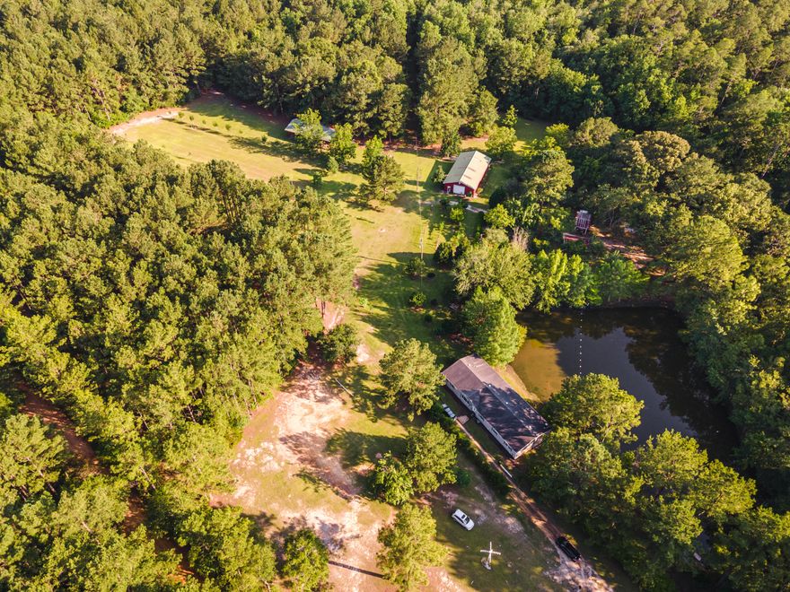 Have you dreamed of country living? If so, look no further on this 38.5 acre property. This is a hunter and fisherman's paradise that backs up to Hurricane Lake. Spacious mobile home with a spring fed pond with dock. The front of the property is fenced. The property has a variety of trees and fruit trees. Large 2-story barn has a bathroom. Other features are a pole barn, shooting house, hunting trails, tree stands throughout the property, cleaning station with electric hoist, fire pit, flowing creek on back of property, and food plot for deer. The home has a gaming area/man cave, built-in office area, a spacious kitchen that overlooks the pond with stainless appliances and an island with breakfast bar. Ceiling fans throughout. So many more features. Schedule a showing today!