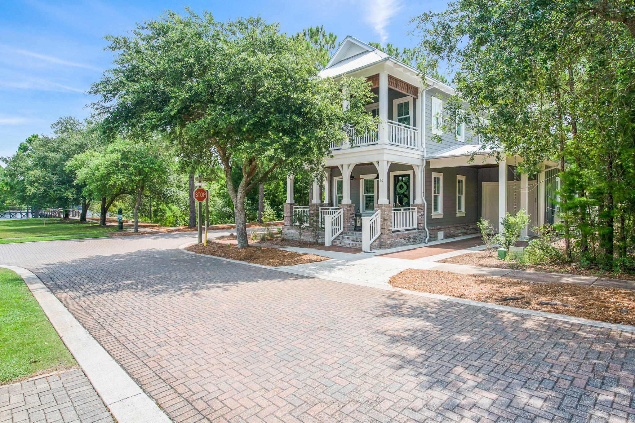 Gorgeous Home on excellent corner lot in 30a exclusive gated neighborhood of Forest Lakes. Designed by renowned architect firm Archiscapes, this beautifully designed and furnished home enjoys fantastic views of green space and lake. Offered Turn-key with Furniture and appliances (including washer/dryer) - all less than a year old - owner minimum usage only! ~ Indulge in the many quality finishes. Attention to detail includes all 4 bedrooms w/ a private bathroom; Outdoor living enhanced by the attractive front porch, as well as the front balcony-sleep porch and a back screened porch for master on first level. Appreciate lots of Storage throughout, including a 1 car garage (extra features added!) also a 1 car carport. (See Exclusions List) For more detail look at the 360 Virtual Tour.