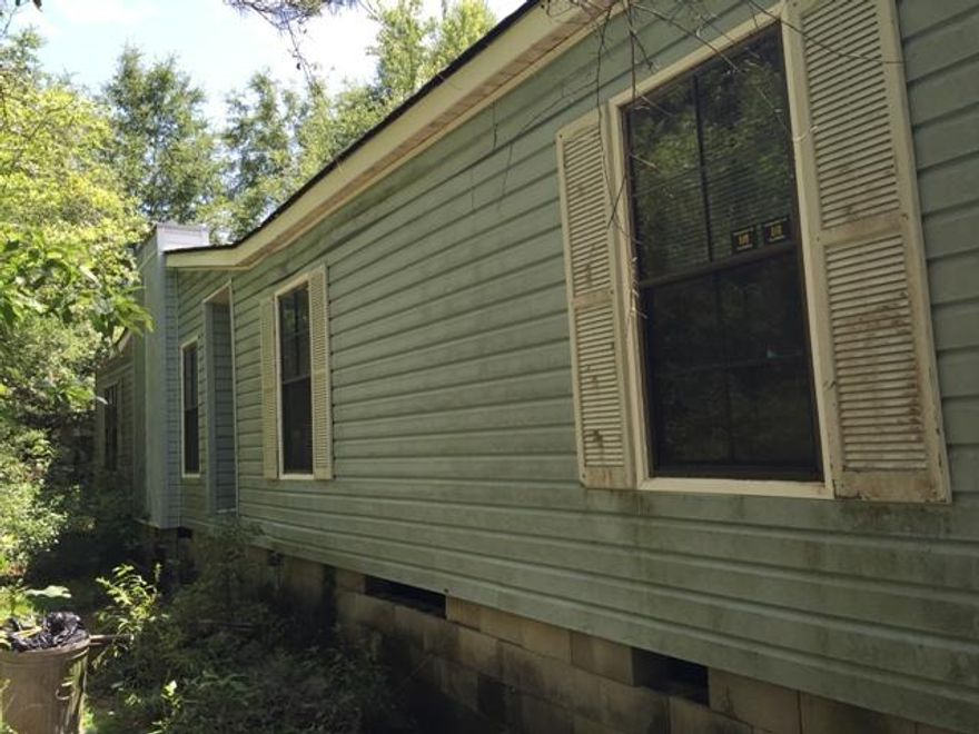 This is a beautiful piece of property tucked back in a secluded area. The home on the property needs extensive repairs.