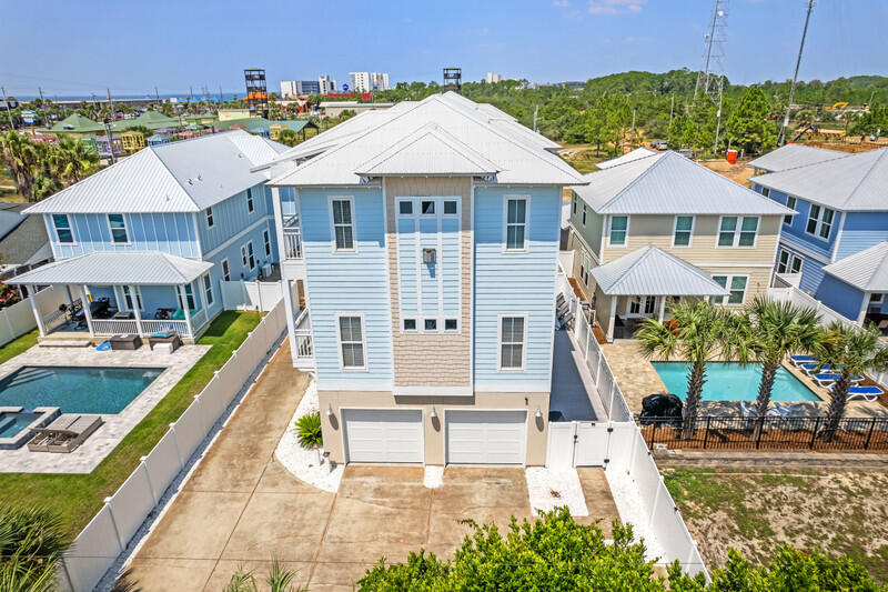 THIS IS IT! Private pool AND cash flowing opportunity! Welcome to your dream investment in PCB! This stunning beach house in Panama City Beach, Florida offers the ultimate combination of extravagance and convenience and comes fully furnished, ensuring that your guests have everything they need for a comfortable and memorable stay.Coming onto the main floor, you'll notice an open living and dining area. A luxurious leather couch, loveseat, and armchair plus a dining room table set for six signifies that everyone is welcome! The fireplace makes the room feel cozy, while the decor and chandelier inspire a sense of opulence. You'll find even more seating at the bar height countertop, where your guests can enjoy a bite or a beverage, or they can partake in conversation or activity on either side of the breakfast bar.
Plenty of cabinets and counterspace, a dual sink, stainless steel appliances, and a fully stocked kitchen are at your fingertips whether preparing a simple home cooked meal or entertaining a houseful of guests. A half-bath rounds out the main floor plan, ensuring both comfort and ease for everyone.
The primary bedroom and one guest bedroom are just up the stairs on the third floor. The sentiment of the primary suite is serene and tasteful, with the fireplace adding a sense of warmth and the double doors leading to the balcony allowing for beautiful natural light. In the primary ensuite, you'll enjoy an abundance of space from the double vanity, garden tub, and huge walk-in shower. The guest bedroom on this floor houses a king bed and two bunks, giving sleeping space for up to four more people. Whether adults or children, the guests in this room will appreciate their own full bathroom, and everyone will be happy to have use of the laundry room with full-sized washer and dryer.
As you explore the ground floor, you'll find yet another bunk room, complete with two sets of bunk beds and an ensuite bathroom. This space offers the perfect retreat for a family or the perfect seclusion for a group of teenagers! Whoever utilizes the downstairs guest room also has quick access to the fenced deck and private pool area, complete with chairs, chaises, and tables, great for a refreshing dip after a day in the sand.
Strategically located in the heart of Panama City Beach, this property is a cash flow generator for investors, drawing vacationers with its prime location and amenities. The M.B. Miller County Pier and access to the beach are less than a quarter of a mile away, hundreds of locally owned restaurants are only moments from your door by car or golf cart, and activities like miniature golf, paddleboarding, jet skiing, shopping, bowling, and more are readily available. Don't miss out on this incredible opportunity to own a slice of paradise that promises relaxation, adventure, and lucrative returns.