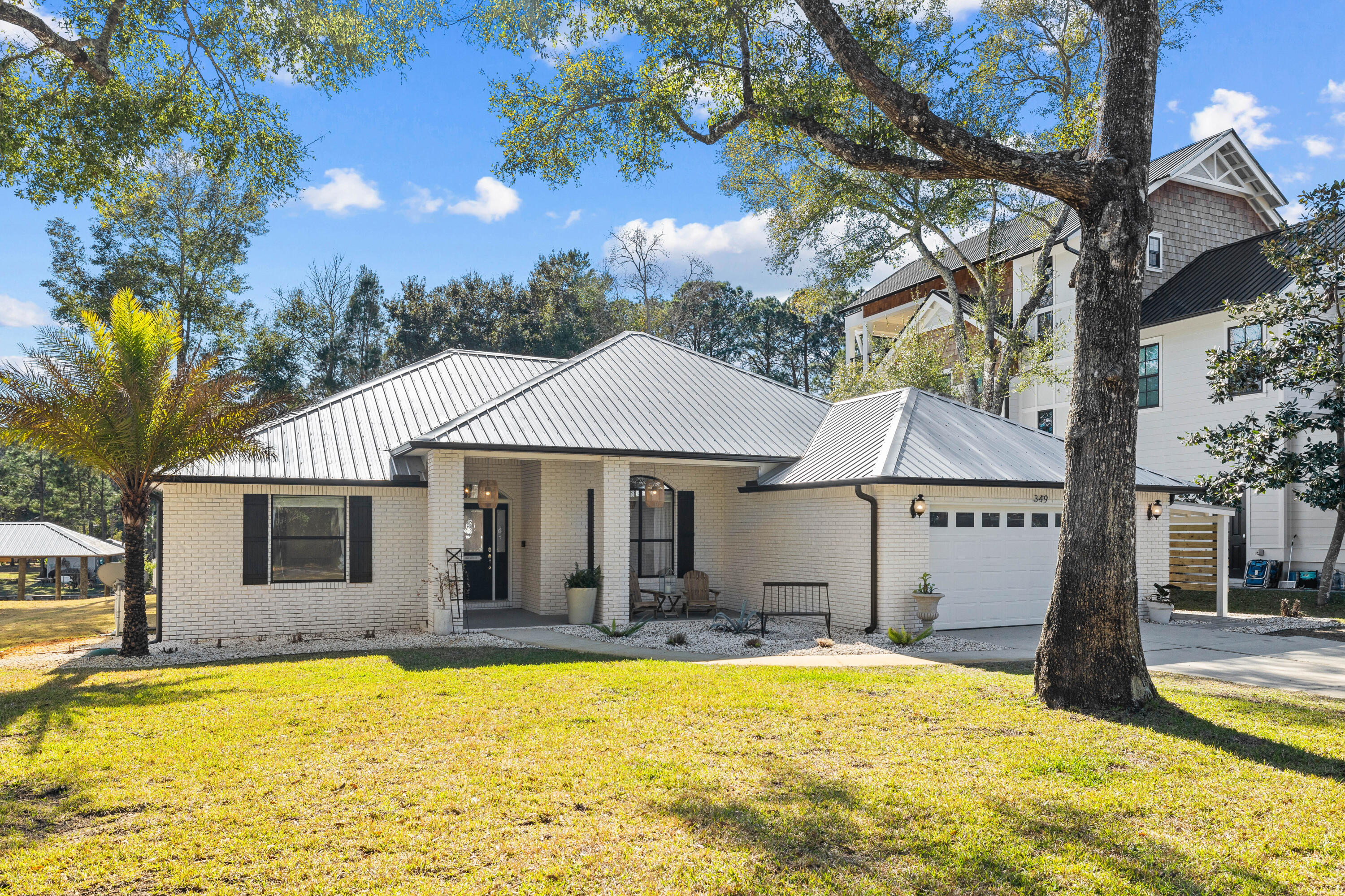 This beautifully updated three-bedroom, two-bathroom waterfront home in Daughettes at Point Washington offers direct access to Choctawhatchee Bay from Little Canal, making it a rare find for boating and outdoor enthusiasts. Spanning 1,923 square feet on a 0.25-acre lot, this brick-built residence features thoughtful upgrades while maintaining room to expand, all without HOA restrictions. A new metal roof installed in 2021 and freshly painted interiors complement the home's inviting layout, enhanced by cathedral ceilings in the living area and 10-ft. tray ceilings in the primary bedroom. The remodeled kitchen is designed for effortless entertaining, with seating for seven around the expansive 42-inch deep countertops, painted cabinetry, and updated appliances. A separate dining area with a built-in sideboard and wine fridge adds elegance to the space.
Outdoor living is just as impressive, featuring 75 feet of canal frontage, a newly built boat lift that accommodates up to 28 feet and 6,000 pounds, new landscaping and sod, in-ground irrigation and newly installed pavers. A two-car attached garage and a side carport for a low-speed vehicle offer ample parking and storage.
Set on the high-elevation northeast side of Little Canal, this home is in Flood Zone X, providing peace of mind. Whether you enjoy boating, fishing, kayaking or paddleboarding, this location is ideal, offering both privacy and proximity to Grayton Beach and 30A. With no HOA and a modest bi-annual dredging assessment, this is a rare opportunity to embrace the waterfront lifestyle without restrictions.