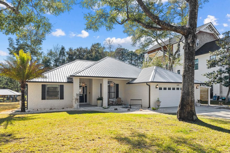 This beautifully updated three-bedroom, two-bathroom waterfront home in Daughettes at Point Washington offers direct access to Choctawhatchee Bay from Little Canal, making it a rare find for boating and outdoor enthusiasts. Spanning 1,923 square feet on a 0.25-acre lot, this brick-built residence features thoughtful upgrades while maintaining room to expand, all without HOA restrictions.  A new metal roof installed in 2021 and freshly painted interiors complement the home's inviting layout, enhanced by cathedral ceilings in the living area and 10-ft. tray ceilings in the primary bedroom. The remodeled kitchen is designed for effortless entertaining, with seating for seven around the expansive 42-inch deep countertops, painted cabinetry, and updated appliances. A separate dining area with a built-in sideboard and wine fridge adds elegance to the space.  

Outdoor living is just as impressive, featuring 75 feet of canal frontage, a newly built boat lift that accommodates up to 28 feet and 6,000 pounds, new landscaping and sod, in-ground irrigation and newly installed pavers. A two-car attached garage and a side carport for a low-speed vehicle offer ample parking and storage.  

Set on the high-elevation northeast side of Little Canal, this home is in Flood Zone X, providing peace of mind. Whether you enjoy boating, fishing, kayaking or paddleboarding, this location is ideal, offering both privacy and proximity to Grayton Beach and 30A. With no HOA and a modest bi-annual dredging assessment, this is a rare opportunity to embrace the waterfront lifestyle without restrictions.
