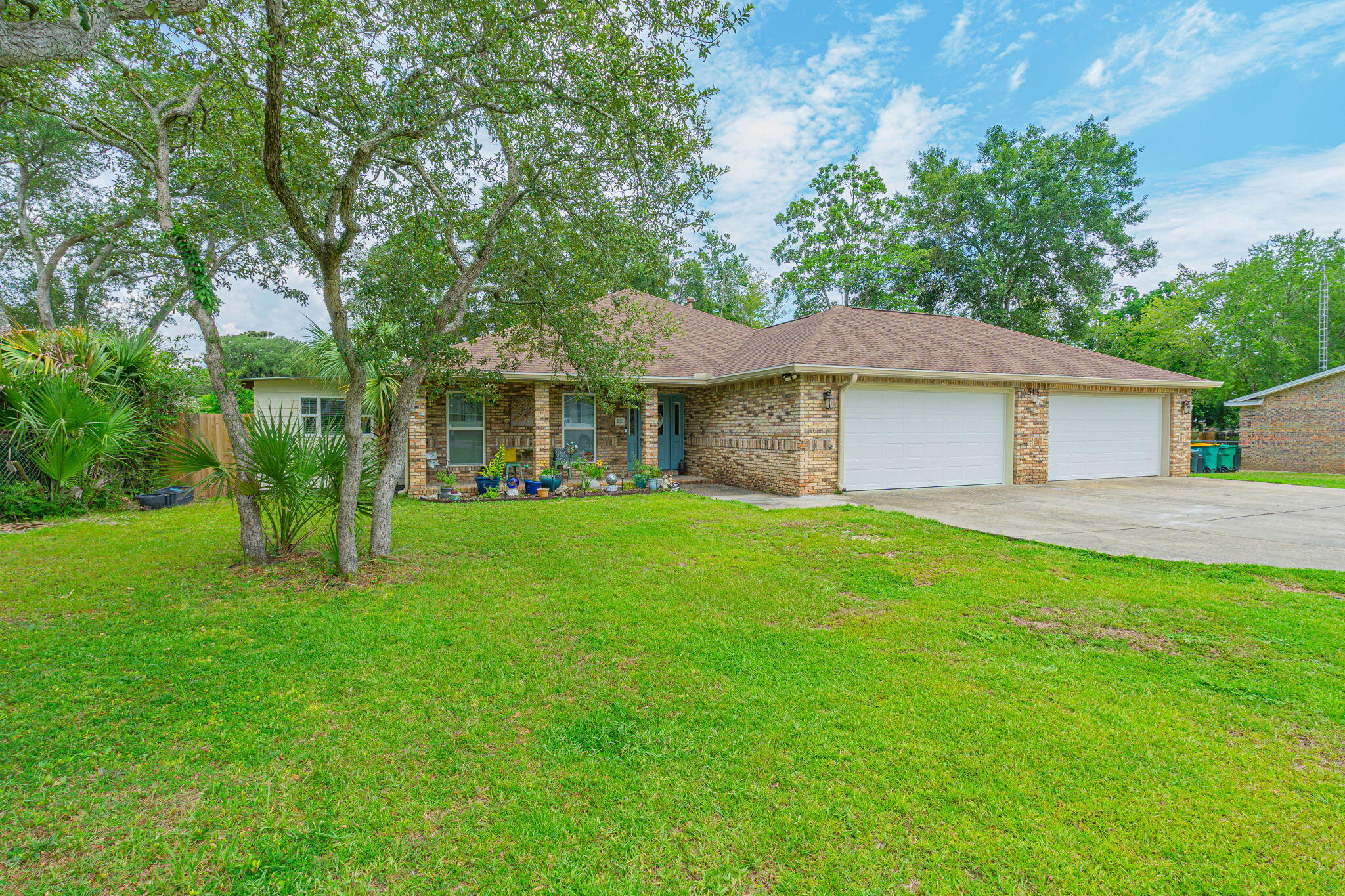 This beautiful brick home has such an inviting and warm appeal it will bring a smile to your face from the start. Upon entering the home you'll find the expanse of an open floor plan with vinyl plank flooring throughout. The kitchen has a bounty of counter and cabinet space--with a large island anchoring it. The family room is large, has a tray ceiling and accent wall--perfect for your TV. The spilt floor plan allows for some privacy for the primary bedroom and en suite bath. You will also find an office/sitting room adjacent to this bedroom, with a split unit Air Conditioner. There are two additional bedrooms with a shared hallway bathroom. The brick, screened porch, just off of the family room functionally extends your living space 8-9 months of the year. (Click MORE) Then there are your garages . . . that's right . . . garages (plural). This home boasts a FOUR car garage--complete with a half bath! The yard has plenty of room to create your own Florida oasis!
With its central location--close to beaches, bases, shopping and dining--it is an ideal home for your next MOVE UP! Roof and water heater replaced in 2018; HVAC replaced June, 2025.