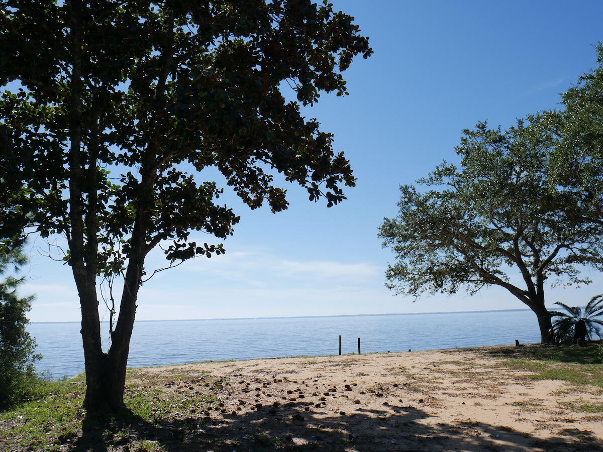 ONE-OF-A-KIND property including BOTH a waterfront home AND a barn with a pasture all backing up to 356 acres of property owned by Eglin AFB!! This VERY unique property between Choctaw Beach and Basin Bayou consists of a total of 1.4 acres with 187' on Choctawhatchee Bay. The home on the waterfront parcel features 2 master suites downstairs as well as 2 bedrooms that share a bath upstairs. There is a formal dining room and the kitchen is open to the family room. There is also a large covered porch along the back of the house with stunning bay views. The property also includes the parcel across the street where you will find the barn, pasture and outbuildings. The area above the barn was converted into living space but is not permitted. The barn was home to several horses throughout the