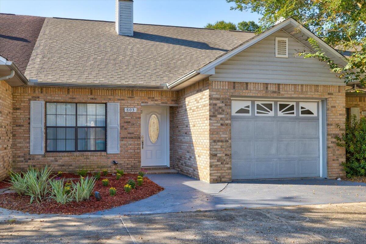 2 Bed, 1.5 Bath Crestview All-Brick TownhomeWelcome to your all-brick and freshly landscaped townhome. Upon entry, note the grandeur of the raised shed ceiling, complimenting the half-walled staircase in the living room--this impressive living space is made cozy by the fireplace with brick hearth and surround.  A wide threshold opens to the dining room with backdoor access to the enclosed back patio and the kitchen.  The new carpet of the living areas transitions to hardwood in the kitchen and laundry room.  The kitchen has a double basin sink, backyard views, and wood cabinets with a provincial stain accenting the natural grain.   Off of the kitchen is access to the laundry room, attached one-car garage and half-bath.