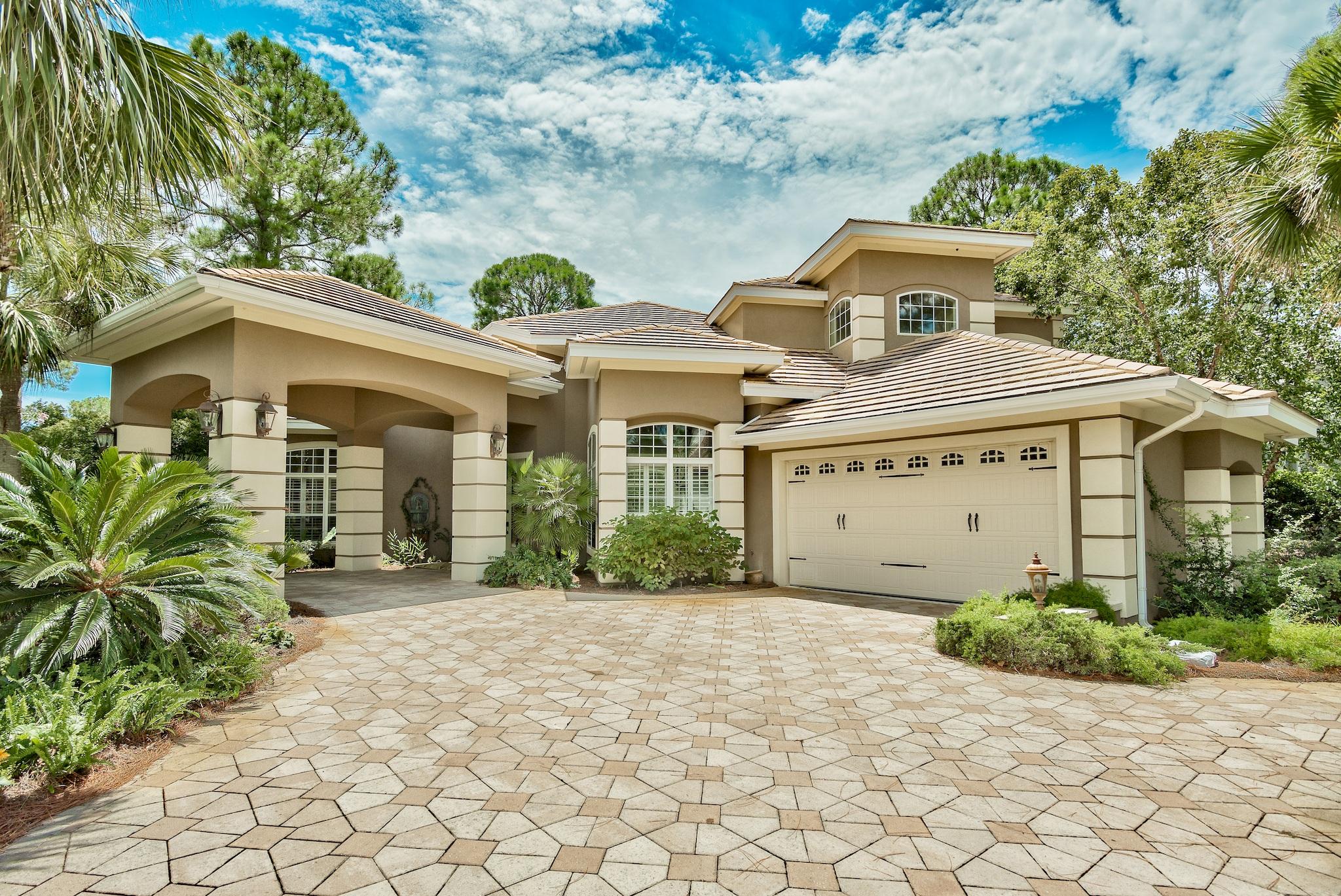 Beautifully updated home, paired perfectly with a lake side setting in the prestigious Burnt Pine community. Gorgeous views of the golf course and lake are abundant from the backyard oasis. An entertainer's dream both inside and out. Custom pool design allows walk out access from the master suite and is complemented with a swim up bar. For those cooler winter months, one will enjoy the attached hot tub as well as the pergola area with outdoor fireplace. There's also an outdoor kitchen for cookouts. Upon entry to the home you will find a spacious living/dining/wet bar combination that flows perfectly into the updated kitchen and contiguous living space. DCS appliances include a 6 burner stove, wall oven, warmer oven and microwave. Quartz countertops round off the finishes along with a