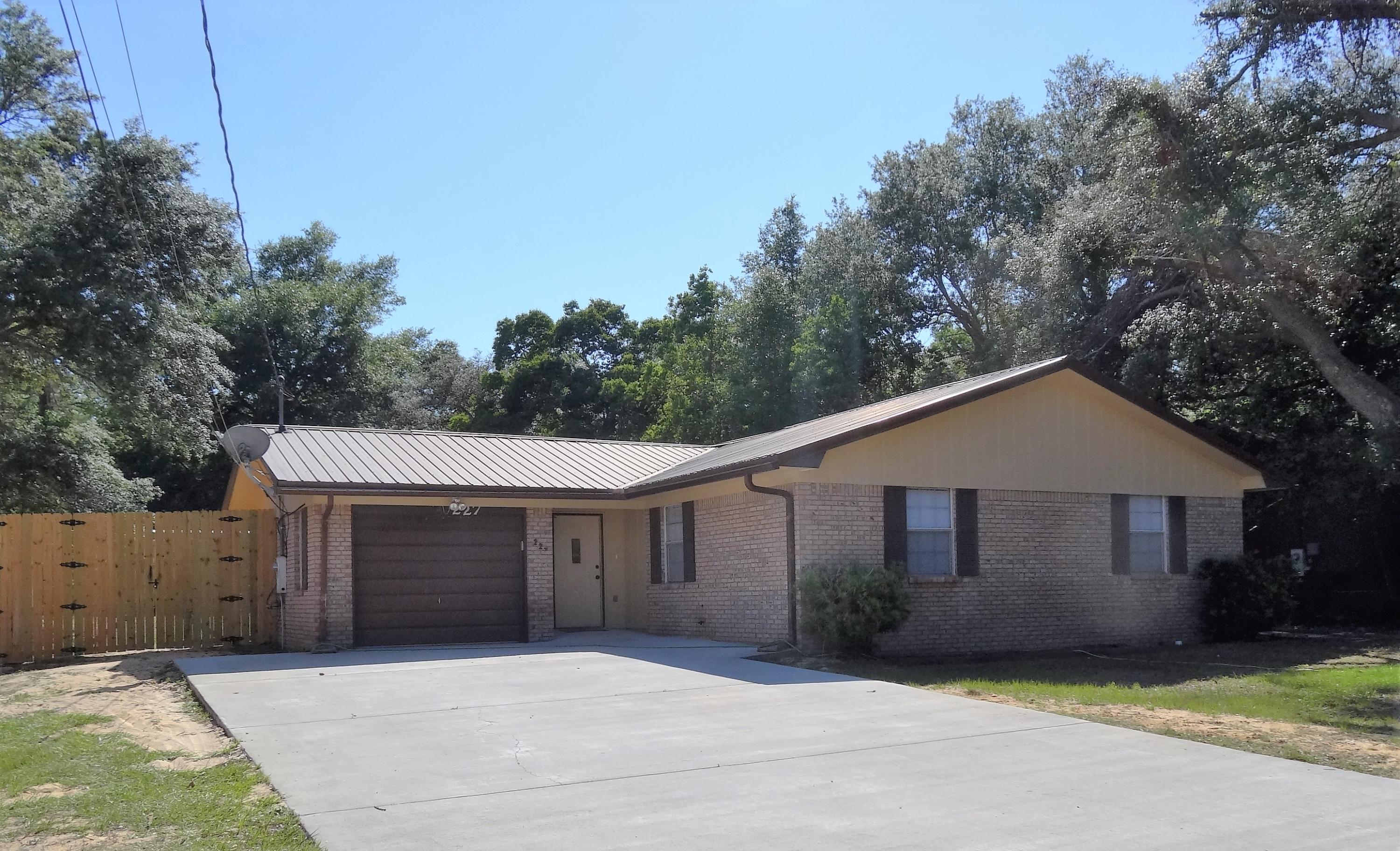In the heart of Niceville, near Ruckel Middle School, NHS, Niceville children's park, library, community center and other Niceville municipal offices is an all brick home ready for a new owner. The kitchen is open to the great room and has dining space plus a breakfast bar. The great room is spacious and has a wood burning fireplace. 2 full baths service the 3 bedrooms and guests. All floors are laminate wood or tile providing effortless maintenance and durability. A metal roof was installed in 2005, the concrete driveway has been replaced and expanded, a new 10' privacy fence with gates in back yard, new interior paint, GE heat pump water heater, and a workshop/garden shed with electricity. The Florida room with 11x5 storage area and patio provides room for multiple activities.