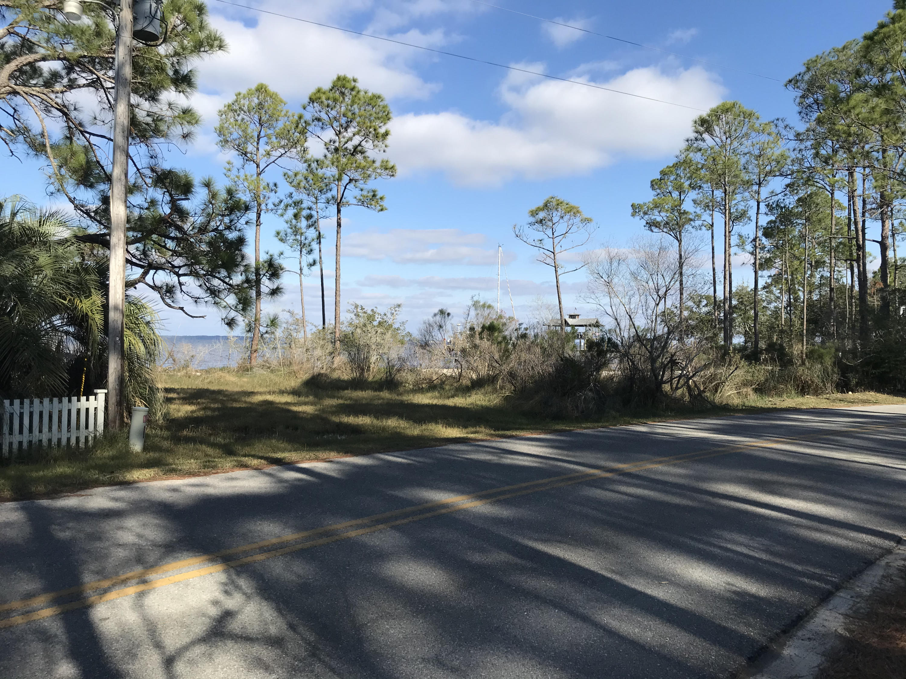 Lovely wooded lot directly across from the Choctawhatchee Bay with potentially beautiful views. The Whispering Pines Bay Front Park is across the street and slightly to the right, affording unblocked Bay views from your future home. This lot is located approximately 6 miles north of Ed Walline Public Beach Access at Gulf Place!