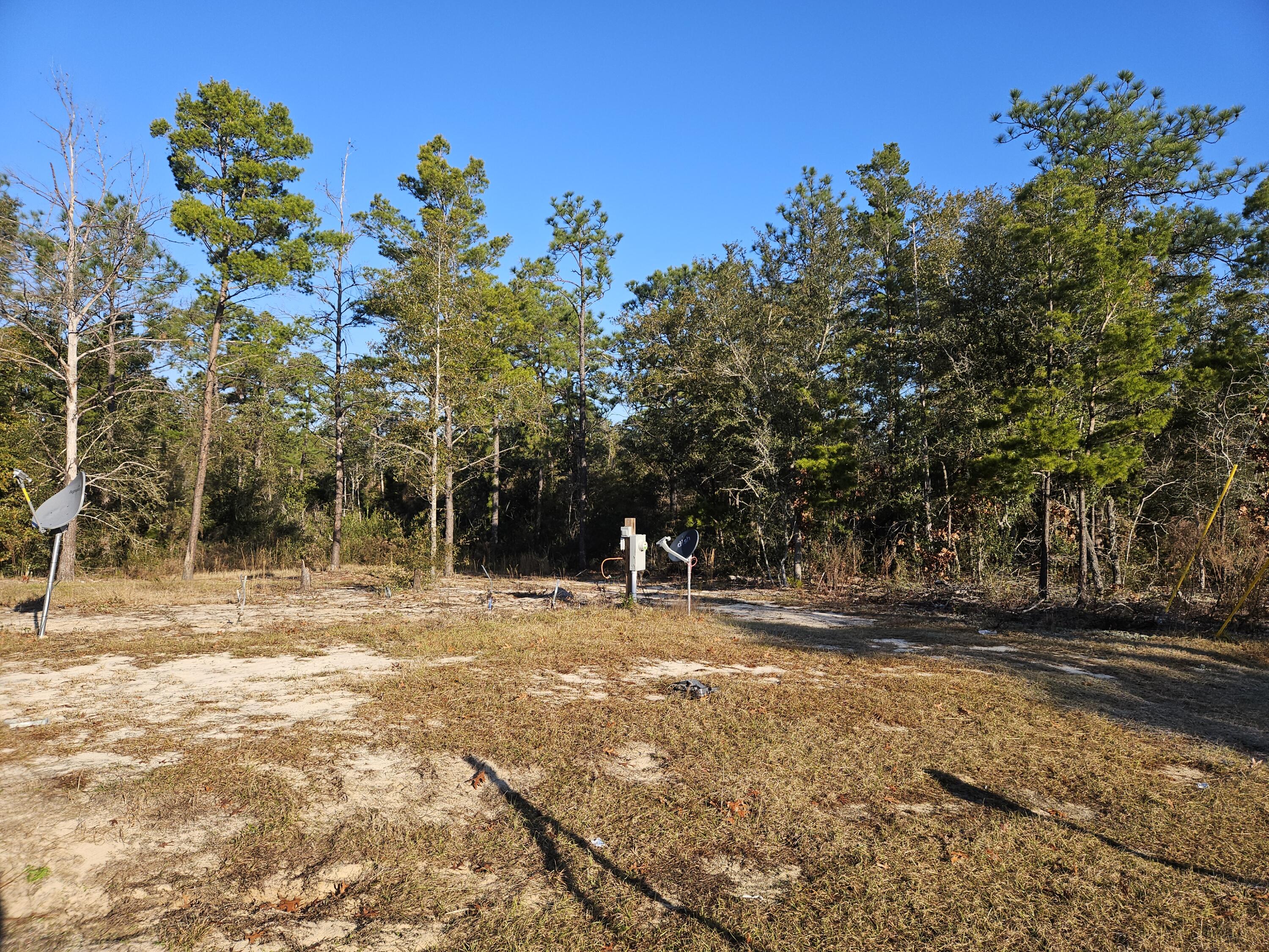 Good building lot on a paved road in close proximity to Hwy 90 and within a few miles of the I10 and Hwy 285 interchange.  Electricity, septic and water in place for you so just bring your home or home plans and be set up in no time.  Homesite cleared with woods remaining in the back.  Located near the cul de sac for added privacy.  Make an appointment with your favorite Realtor today to take a look!