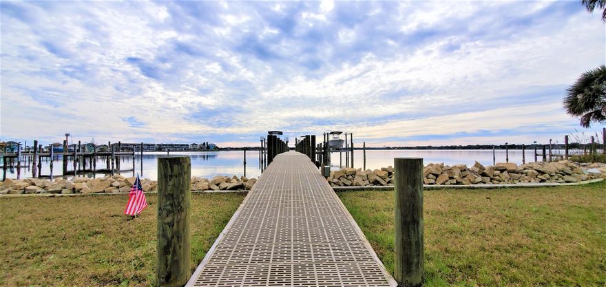 Move right into paradise at this beautiful waterfront townhome with no HOA! On the crystal clear water you will be impressed with the brand new, almost 50K dock with high end Flow-Thru decking, new pilings, new boat lift with remote control, new custom built fish cleaning table, solid sea wall with additional rip-rip added, and a new swim/yolo/kayak deck. Bring the big boats...the water is 16 ft deep at the boat lift. Dock has 3 slips that are owned with 2 other boaters. Watch the sunrise and sunsets, from the 32x10 screened porch area that includes an attached covered porch. Go inside to the kitchen, where you will be very pleased with the 12 ft long granite topped kitchen eat-in bar, stainless steel appliances, gas stove for the chef, abundance of new cabinets, pantry, and inset lighting Cozy up to the wood burning fireplace while taking in the views of the sparkling Garnier's Bayou. The garage has had a 15K renovation to include replacing standing poles in the center with LDL support beams in the ceiling so you will have a big open unobstructed space. Water view from ALL major rooms! Porches have 640 sq ft of outdoor living! NEW: HVAC system (includes gas heat and new vents and ducts) with UV Purify Air Light, washer and dryer, flooring (tile on first floor), paint, heated and cooled bonus room off master, tankless water heater, garage door and opener, toilets, custom built storage shelves in garage, and wide outdoor stairs and ramp, 3 rail fence. 5 minute boat ride through the Bay to Crab Island, 10 minutes to the Destin Harbor. Location is prime! Easy access to FWB Medical Center, Hurlburt, Eglin, shopping, and exquisite dining. Bonus: Steel hurricane shutters, lots of storage closets, 30 ft long upper deck, and come see the rest!
