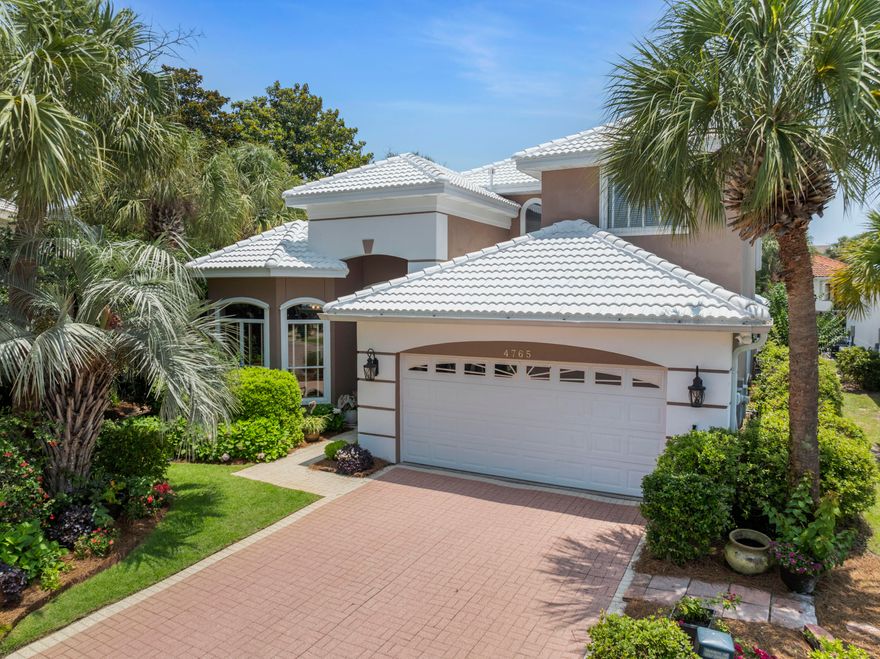 Live at the beach in Destin in the exclusive gated community of Destiny East with outstanding amenities!  This beautiful custom built home sits on one of the largest lots in the community, almost a quarter acre. The lush landscaping around the house, designed by the Master Gardener Seller, is a must-see with stunning tropical plants, flowers, and mature trees including fruit trees.  First level presents a comfortable and inviting open living/dining and gourmet kitchen with a view of the pool and yard. This first level has a library/den, large primary bedroom suite with french doors opening to the lounge area and pool, and a guest bedroom.  Second level has two additional guest bedrooms. Ceilings are 12', 10' and 9'. There are Custom Cherry Cabinets in kitchen and library. Other features include Crown Molding and Trayed Ceilings, Central Vacuum, a new Generac Generator, a new roof installed May, 2025, new primary bath shower remodeled 2025, new fiberglass front door, new AC's, new gas water heater.  The house is wired for Security with land line, and has Hurricane Shutters. The Pool was resurfaced and Pool Enclosure replaced in 2021; In 2024 the pool deck was resurfaced and painted,  and pool pump, spa pump and control panel replaced.  The house is wired for Sound with speakers throughout including the Pool area. Seller has property inspection and stucco inspections and seller has made repairs. Amenities for the community are two pools, Clubhouse, Fitness Center, Theatre room, Playground, Tennis and Pickleball.  Easy beach access from this community.