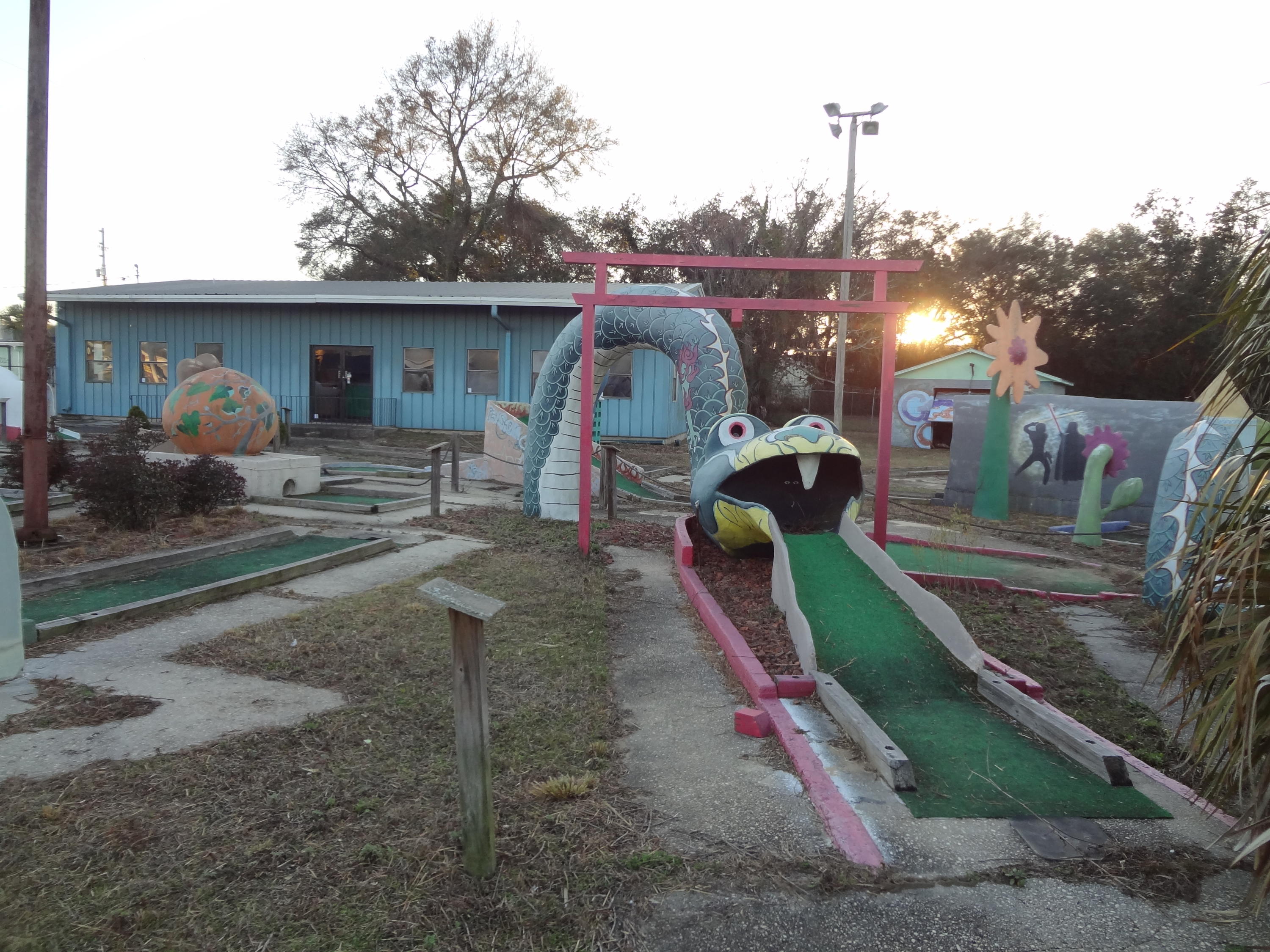 Vacant 36-hole mini golf facility with 2,400 SF office/retail area located on the northern border of Navy Boulevard (US Hwy 98). Property also offers a 1,025 SF 3 BR/2 BA manager's residence with separate drive from Navy Boulevard (currently occupied on a month-to-month basis) which could be utilized as additional office area. Accessory sturctures included a concrete block storage building/detached garage (with electricity) and a four-station batting cage.
