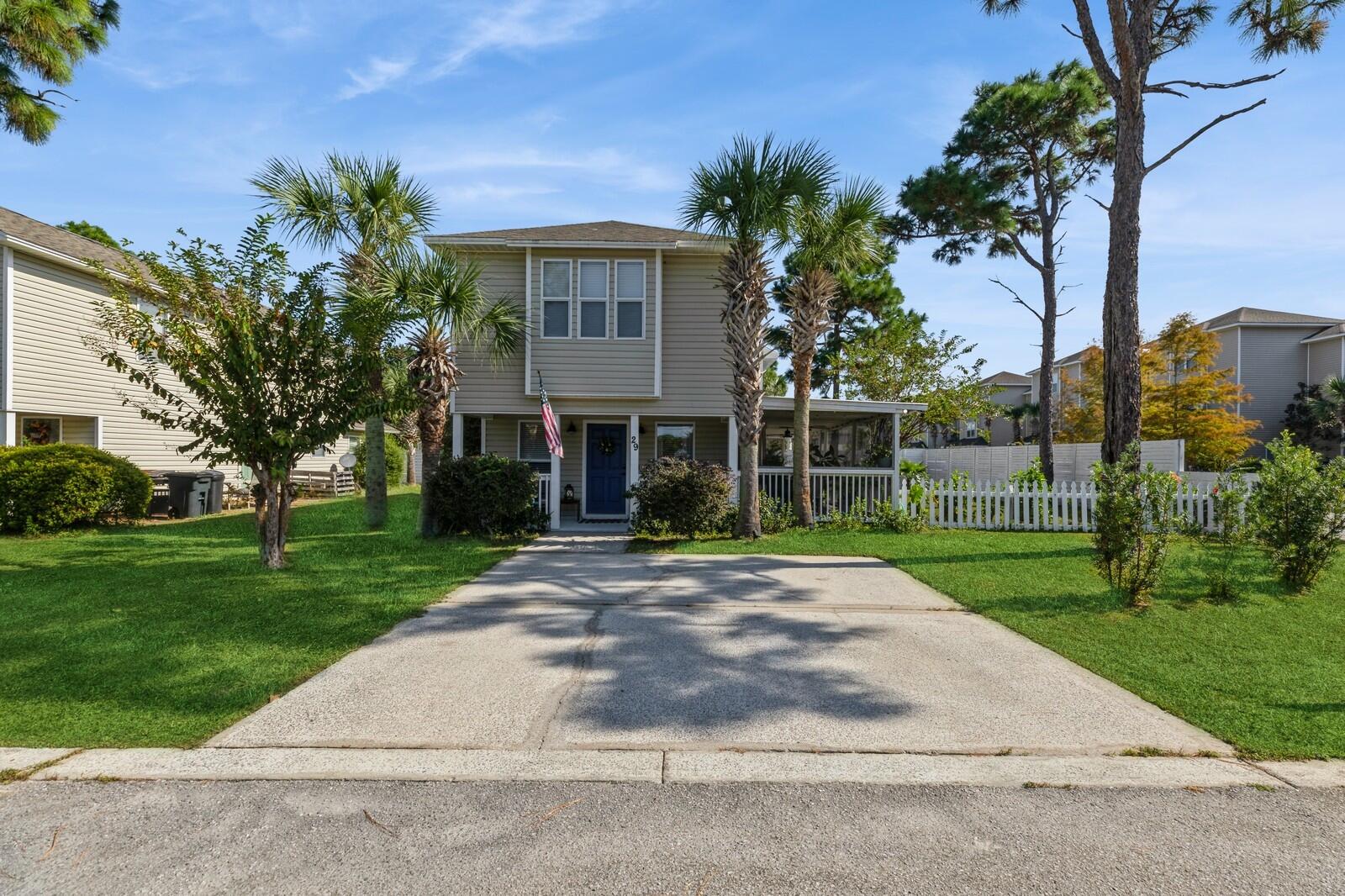 Welcome to 29 Enchanted Way in Enchanted Estates, a charming two story Coastal Style single family residence in a prime location. This delightful home offers wood floors throughout the home 3 bedrooms , 2.5 bathrooms , open concept living space, as you step inside, The main level boasts a spacious living room that flows seamlessly into the dining area and kitchen, stainless steel appliances, ceramic farmhouse sink, chef inspired island. The first level bedroom with an En Suite bath offers dual vanity and plenty of cabinet space for storage. The stair case are wood treads and risers with a wood landing leading to the upstairs. Two large bedrooms await, wood flooring throughout, ceiling fans in both rooms, both with walk in closets for storage outside. The property has a full privacy fence, large covered  front porch and a screened outdoor living with a metal roof 4 screen door leading to the tanning deck, the backyard and to the covered front porch providing ample space for outdoor relaxation, entertaining family, guests or simply unwinding after a long day. The large yard is well landscaped with mature trees and shrubs. HOA takes care of all lawn care, cutting grass, trimming shrubs/trees etc. Enchanted Estates offers a community pool with clubhouse and a dog park. The neighborhood is beautifully landscaped and well maintained by the HOA. Just minutes away from the well renowned 30-A and old 98 scenic beaches and emerald green waters of the Gulf. Nearby amenities include Sacred Heart Hospital, Grand Boulevard for upstairs retail and dining, entertainment options, movie theater, Publix, Sandestin Resort, Baytowne Wharf, and championship golf courses ensuring a lifestyle of convenience and leisure. 