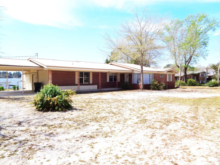 NEW PRICE!!Opportunity to own property on Lake Stanley - This is a large, spacious home that has 152 feet on the Lake. Lots of potential in this home. 3 bedroom, 3 baths, oak floors in Living Rm, 8 x 56 covered porch on the back of the home. Original garage has been enclosed for the laundry/workshop with half bath. Dock on the lake that needs work. This Lake offers fishing, swimming and boating. Now is the time to buy and make this a dream home. Home will need some TLC.