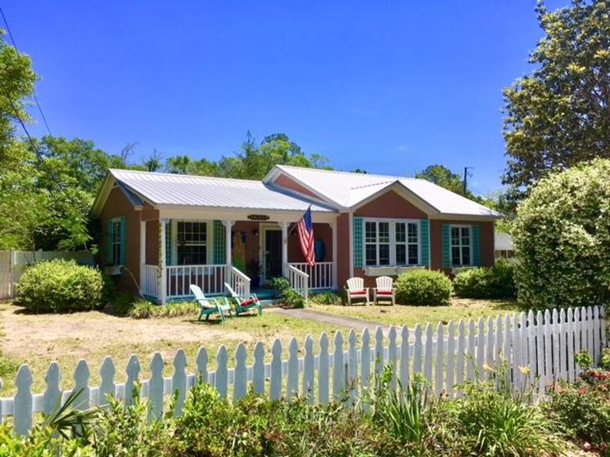 CHARMING COTTAGE IN TOWN! Known as Mermaid Cottage, this adorable 2BR 2BA home is located just a few blocks from Lake DeFuniak and downtown. Front & back porches on this updated 1940 cottage allow enjoyment of the 1/3 acre fenced lot, sporting fragrant jasmine hedges, privacy decks, and a 12'x18' yard building. Attached one-car garage has direct access to the house. The open kitchen with newer stainless appliances plus gas range flows into a dining area and den/sitting room. Original oak floors lead to the living room with fireplace, foyer, and two spacious bedrooms. One Bath features an oversize jetted tub, and the other has a walk-in shower. Built-in shelving, crown molding & beaded wainscoting throughout the house. Washer/Dryer included. Plus newer central heat & air and metal roof.