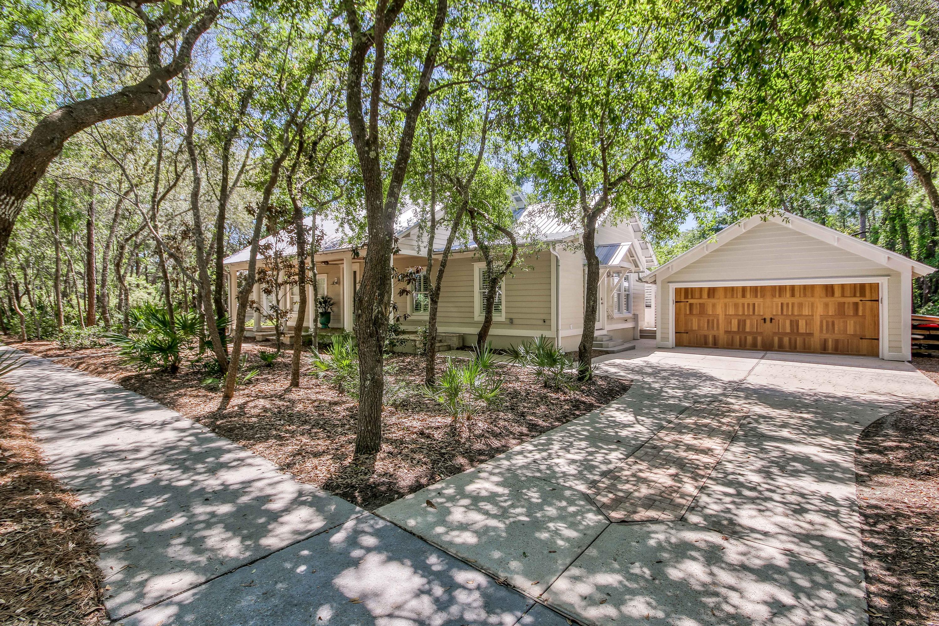 Located in the exclusive, gated community of Lake Place in Grayton Beach, this completely renovated Old Florida, charming cottage offers the opportunity to live minutes from the downtown Grayton Beach, WaterColor and Seaside while being South of Scenic 30A. Walking up to the home, you are greeted by a large covered front porch perfect for an afternoon of relaxation. The living room boasts a cathedral ceiling, gas fireplace as well as beautiful hardwood flooring. In the kitchen, you'll find an abundance of gorgeous cabinetry, quartz counter tops, a built-in wine fridge, a bar sink and stainless appliances. Experience the outdoors in the lovely screened porch and spacious open-air deck perfect for hosting family meals. This home also comes equipped with a detached two-car garage