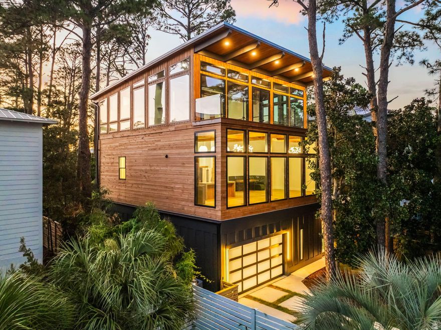 Set aside the Gulf of Mexico and one of 30A's rare coastal dune lakes, this newly constructed modern retreat offers a combination of water views and design details that's seldom found along 30A. Thoughtfully designed across three levels, this four-bedroom home features a private pool, expansive balconies with Ipe decking, and a first-floor lockout suite with its own kitchenette complete with an oven, dishwasher, microwave, and refrigerator, making it ideal for guests or short-term rental flexibility.Inside, the home showcases soaring ceilings, a beamed ceiling in the main living area, and an open-concept kitchen outfitted with quartz countertops, a large island, and premium appliances. Oversized Anderson windows flood the interior with natural light while framing the coastal surroundings. A Eurowall folding door on the first floor seamlessly opens the indoor living area to the outdoor pool deck, creating an exceptional entertaining space.

The master suite is designed as a true retreat, featuring a sitting area with Gulf views, a wet bar, a large walk-in closet with its own washer and dryer, and a luxurious spa-like bathroom. The master bath includes a spacious tiled shower with dual rainfall shower heads, frameless glass doors, and even Gulf views from the shower itself, delivering a true resort-style experience.

The private pool is currently under construction and scheduled for completion very soon, allowing the future owner to enjoy the full outdoor living experience. The pool area will feature a Peacock paver deck, lush landscaping, and direct exterior access from the first-floor suite, perfect for hosting guests or creating a separate rental opportunity.

The home also includes a large two-car garage that is air-conditioned and plumbed for a utility sink, though not counted in the total heated and cooled square footage. You will also find laundry conveniently located on all three floors.

Situated just minutes from two nearby beach access points, West Allen Loop and Lake Causeway, the location offers quick access to the sand and surf, along with close proximity to some of 30A's most beloved local spots. Enjoy fresh Gulf seafood and live music at Stinky's Fish Camp, or grab a cold drink and watch the sunset from Shunk Gulley Oyster Bar. Whether you're relaxing poolside, entertaining guests, or heading out for a beach day followed by dinner nearby, 129 Oyster Lake Drive delivers a lifestyle that captures the very best of new construction living on 30A