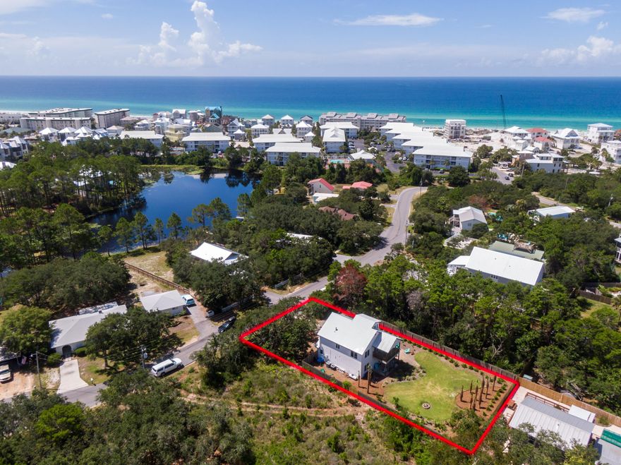 Location is everything! Stunning, unique property south of 30A. Beautiful home with a huge lot, never rented, just steps to multiple public beach and Eastern Lake access-points. Open kitchen features granite countertops, Stainless appliances, double oven and spacious island. Enjoy remodeled baths, brand new flooring, fresh exterior and interior paint, plus energy-efficient shutters and digital thermostats. The home boasts 3 bedrooms and two full baths with a spacious third floor office that could be transformed into a bunk room. This spacious home is nestled cozily near the front of a beautiful private lot filled with 30A signature scrub oaks, palms and fruit trees. Lots of storage, big mudroom and 1-car garage for beach toys and golf cart parking.  The landscaped and irrigated backyard is a private retreat with sundeck, covered patio and outdoor shower, plus plenty of room for a pool.